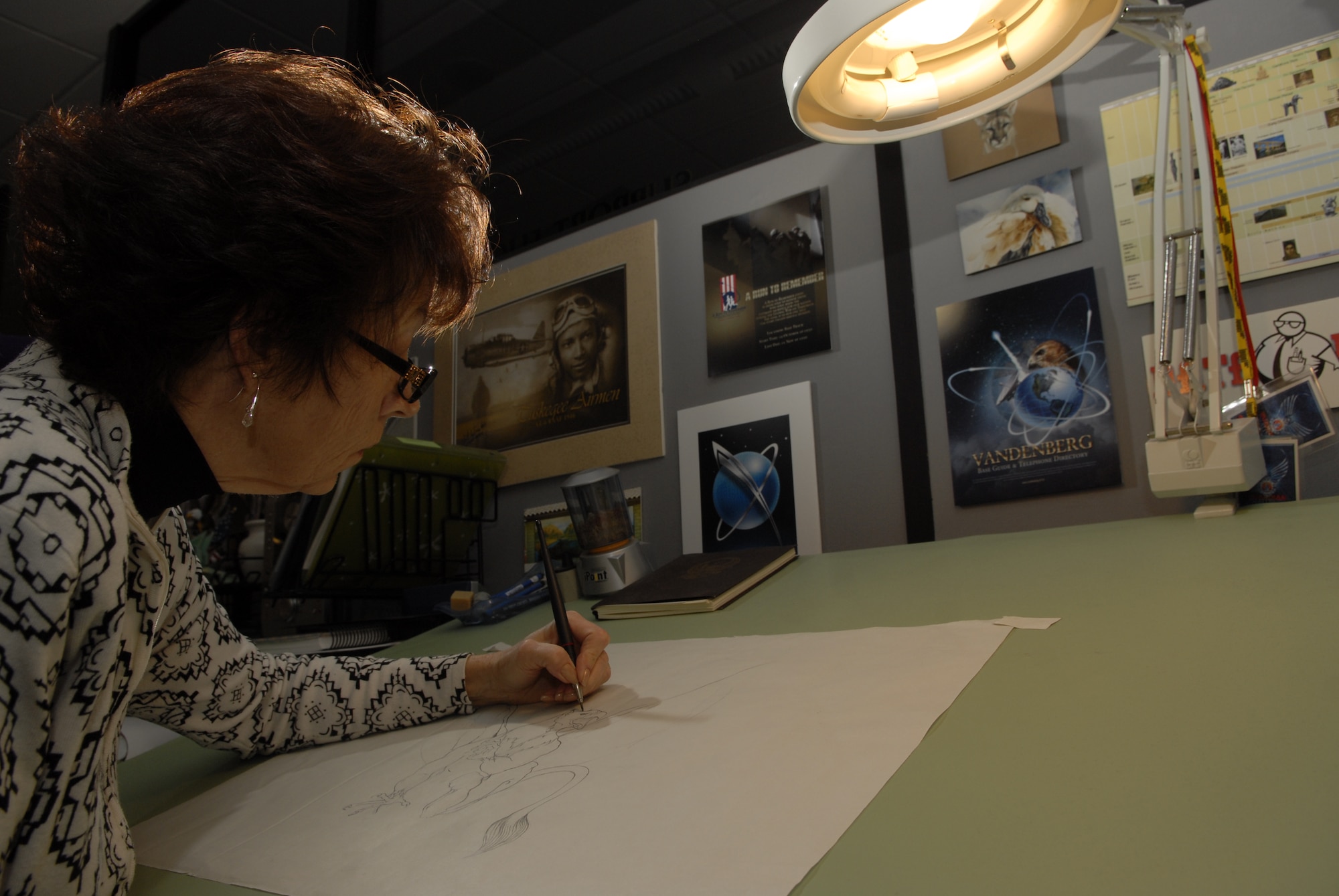 VANDENBERG AIR FORCE BASE, Calif. – Jan Kays, a 30th Space Wing Public Affairs graphic artist, works on a project at her desk here Wednesday, April 27, 2011. (U.S. Air Force photo/ Staff Sgt. Andrew Satran) 