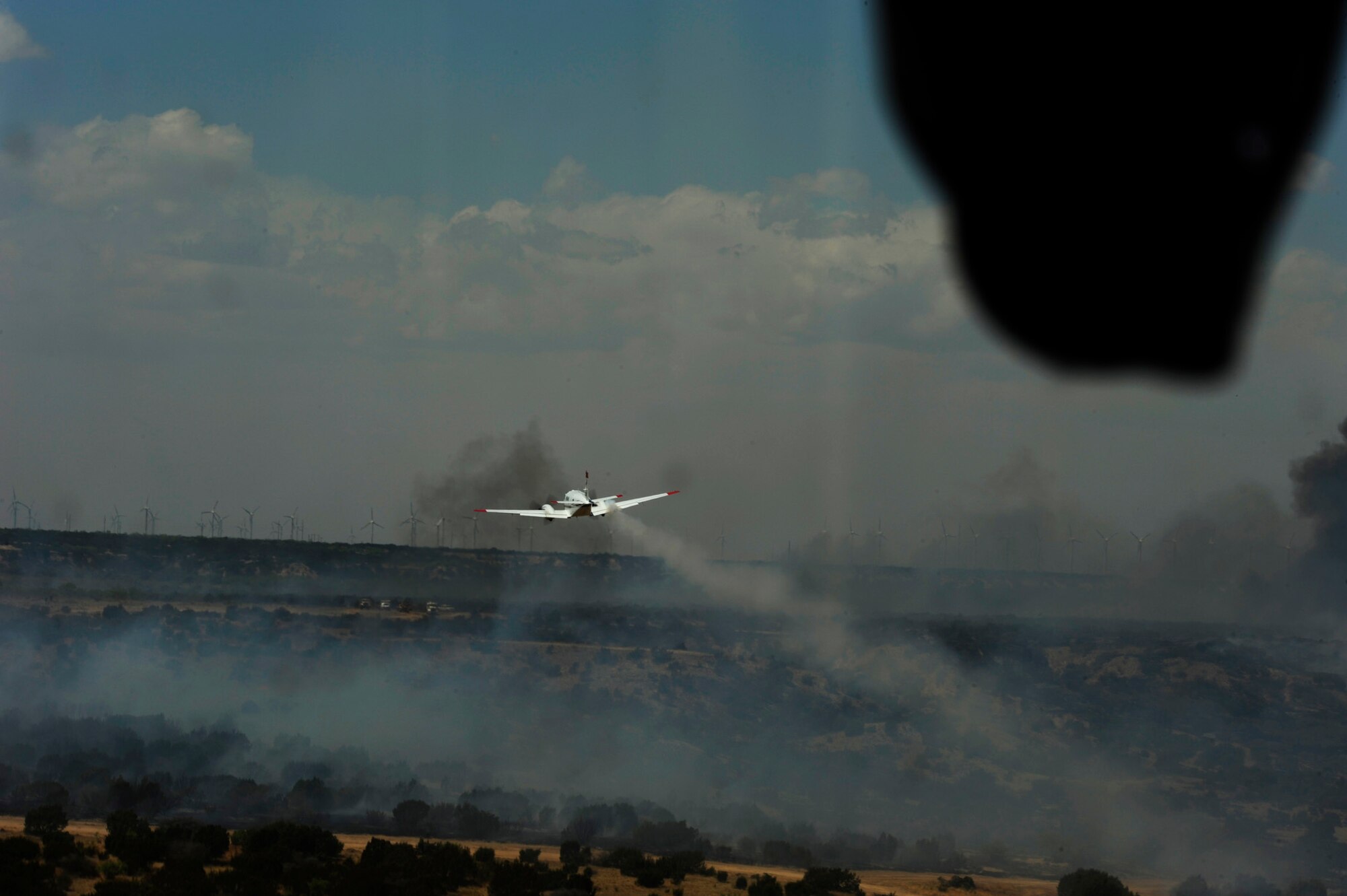 A U.S. Forest Service King Air lead plane guides a C-130 Hercules from the California Air National Guard’s 146th Airlift Wing April 26, 2011, during firefighting operations in Scurry County, Texas.  The lead planes guide aircraft equipped to dispense fire retardant to ensure that the retardant is dispensed where it is needed.  Wildfires have spread across various parts of Texas and have burned more than 1,000 square miles of land.  (U.S. Air Force photo/Staff Sgt. Eric Harris)