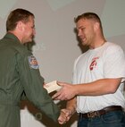 Jeremy Elmore, right, is congratulated by Col. Russ Mack, the 71st Flying Training Wing commander, during Vance AFB’s 2011 Biggest Loser competition reveal ceremony held April 26. Mr. Elmore earned first place in the male category by dropping 50.8 pounds since the competition began in January. (U.S. Air Force photo/ Roger Betz)