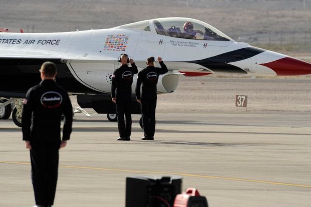 Maj. Aaron Jelinek, Thunderbird #5, gives a "solo salute" to his crew chiefs, Staff Sgt. Jonathan Mitchell and Tech. Sgt. Sam Shineflew, shortly before takeoff at Nellis Air Force Base, Nev., March 10, 2011. The Thunderbirds will headline AirPower over Hampton Roads, Langley AFB's signature air show, May 13-15, 2011. (U.S. Air Force photo/Staff Sgt. Richard Rose, Jr.)