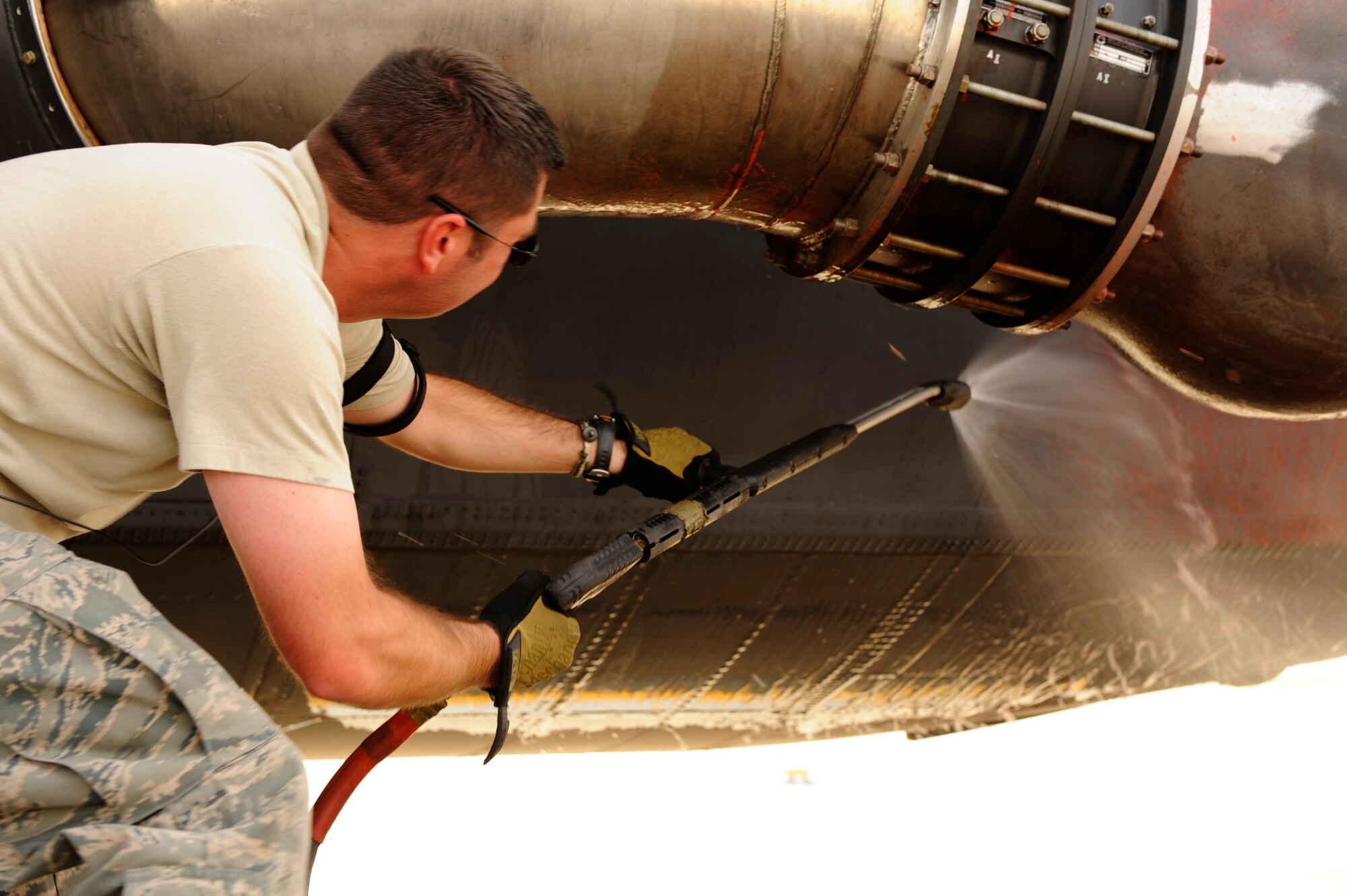 U.S. Air Force Tech. Sgt. Christopher Zinc, 146th Aircraft Maintenance Squadron, California Air National Guard, washes fire retardant off of a C-130J Hercules after a day of firefighting at Dyess Air Force Base, Texas, April 26, 2011.  The fire retardant is highly corrosive, so it needs to be washed off as soon as possible to prevent damage to the aircraft.  (U.S. Air Force Photo/Staff Sgt. Eric Harris)