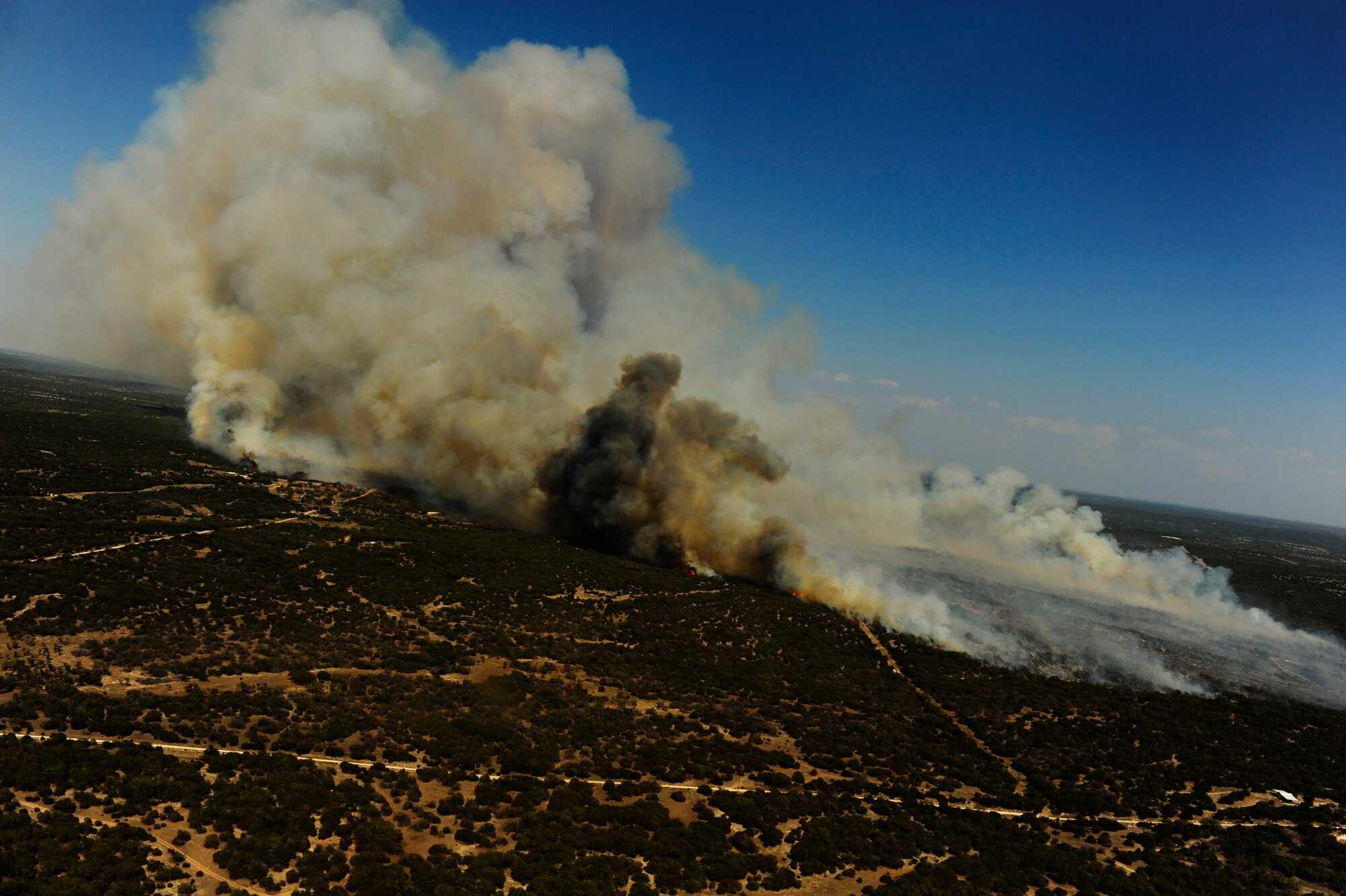 The Oasis wildfire burns in West Texas as fire fighting crews try to contain it, April 26, 2011.  Wildfires have spread across various parts of Texas and have burned more than 1,000 square miles of land.  (U.S. Air Force Photo/Staff Sgt. Eric Harris)
