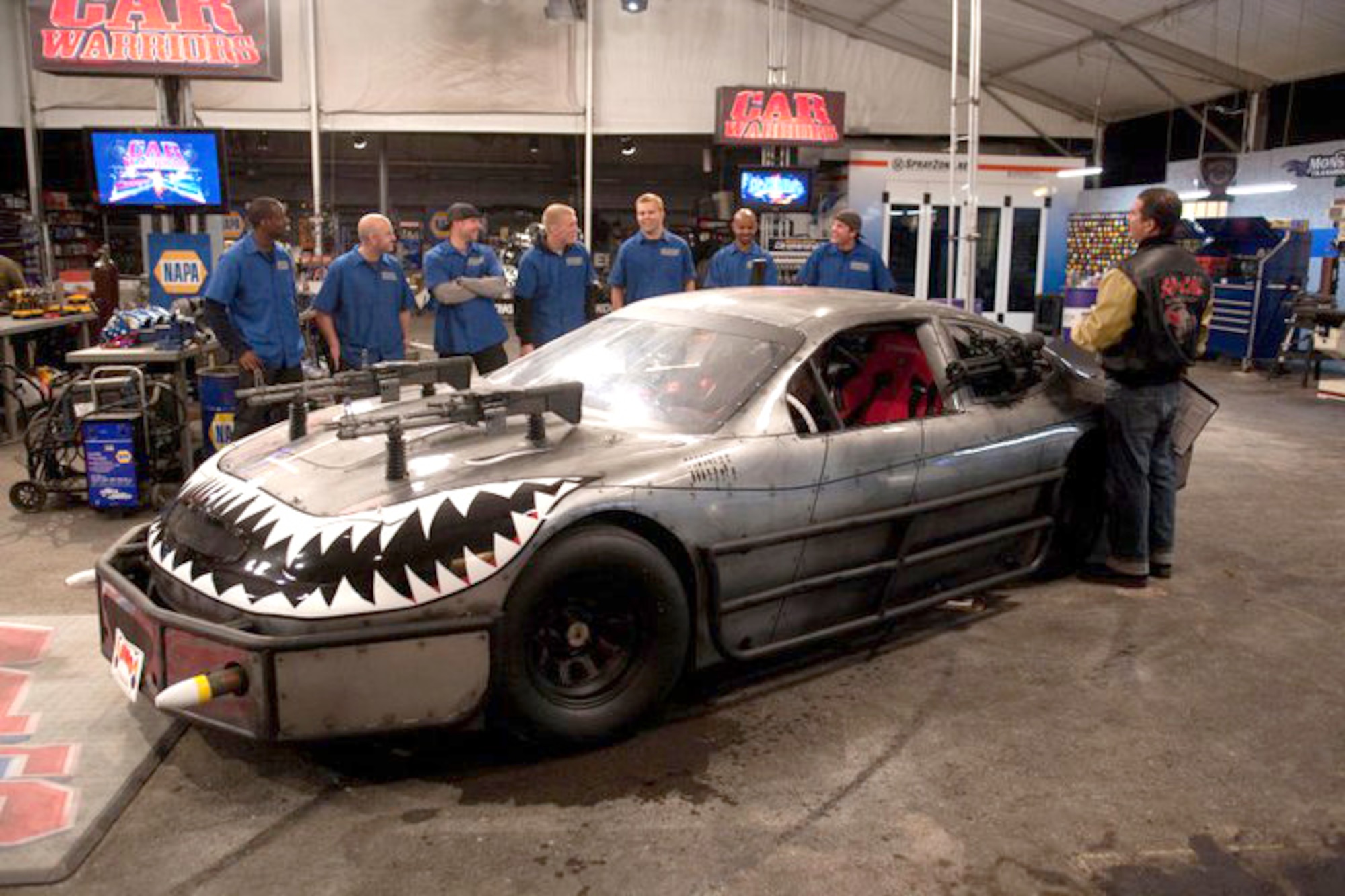 A team of Airmen from Edwards Air Force Base, Calif., stand behind their four-wheeled "A-10 Thunderbolt II" on the set of "Car Warriors," a car-building competition series on the Speed Channel. The Air Force team had 36 hours to plan and build a "NASCAR Death Race Machine" from a bare race car. The group of Airmen took home bragging rights after beating the all-star team of show regulars with a better finished product. (Courtesy photo)