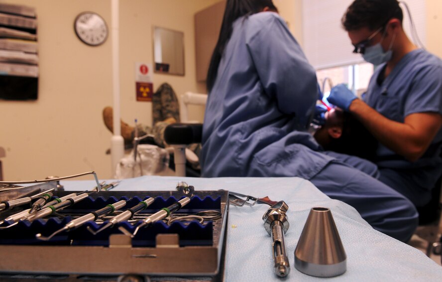 Dental instruments wait as personnel from the 23rd Aerospace Medicine Squadron examine a patient at the 23rd Medical Group Dental Clinic at Moody Air Force Base, Ga., April 27. All instruments are sterilized before and after use on patients, to ensure no diseases or germs are passed from patient to patient. (U.S. Air Force photo/Airman 1st Class Benjamin Wiseman)(RELEASED)
