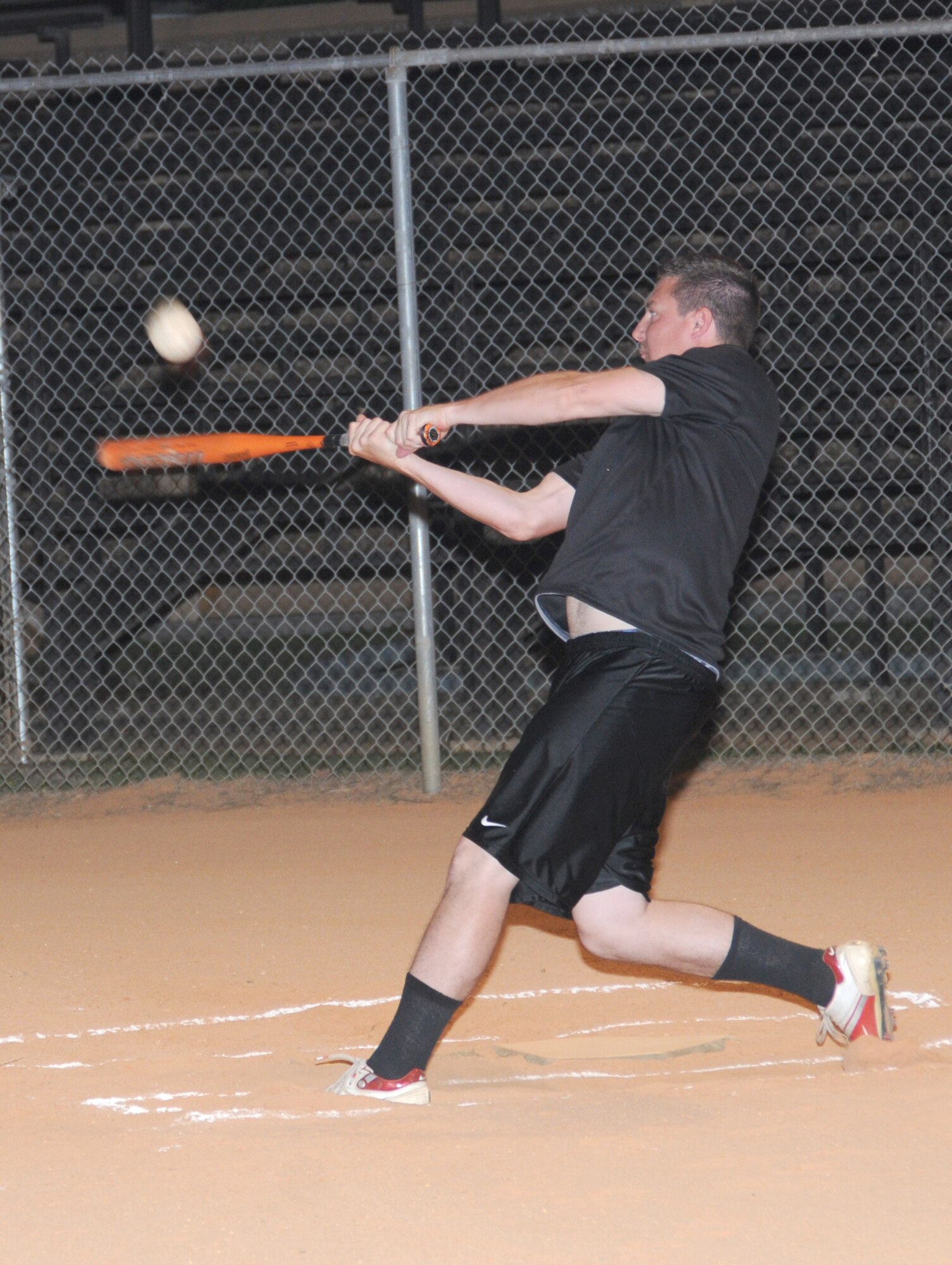 Nickolas Holbrook, a student in the 336th Training Squadron, takes a swing during Saturday’s midnight softball tournament. The Red Wolves beat the first sergeants team in this game, but two teams from the 338th TRS met in the final game, with the 338th TRS Bananas coming out on top.  The event was intended to offer students an alternative to alcohol, and no students were cited for alcohol-related offenses over the weekend.  (U.S. Air Force photo by Kemberly Groue)