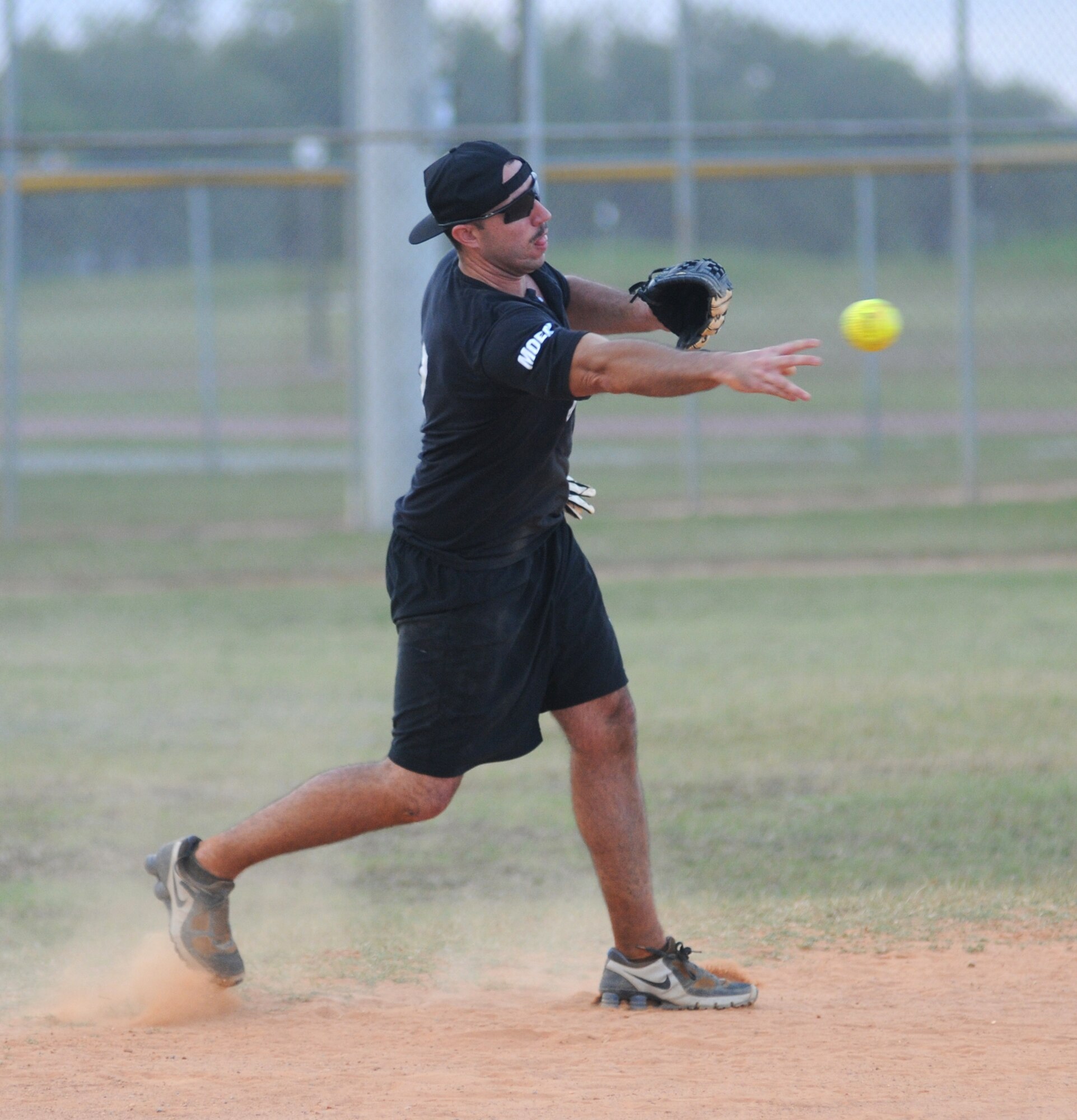 Shortstop Joseph Regan, 335th TRS, throws the ball to first base for an out during Monday’s game against the MARDET-B team. The Bulls won, 19-12.  (U.S. Air Force photo by Kemberly Groue)