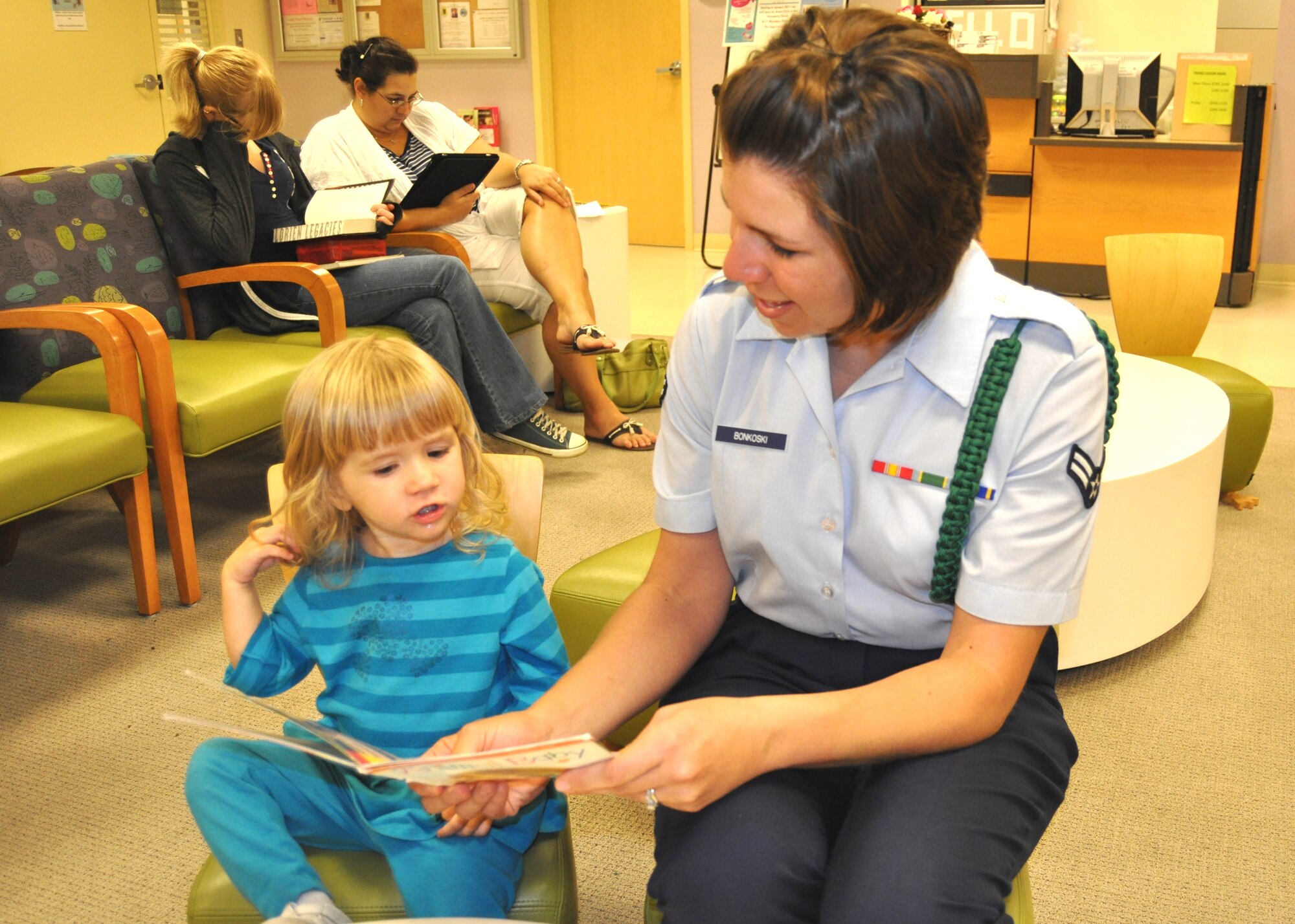 Airman 1st Class Jackie Bonkoski and daughter Arya, 2, enjoy a book in the 81st Medical Operations Squadron pediatric clinic April 18. The clinic boasts the first and longest-running “Reach Out and Read” program in the DOD. Airman Bonkoski is a 334th Training Squadron student.  (U.S. Air Force photo by Steve Pivnick)