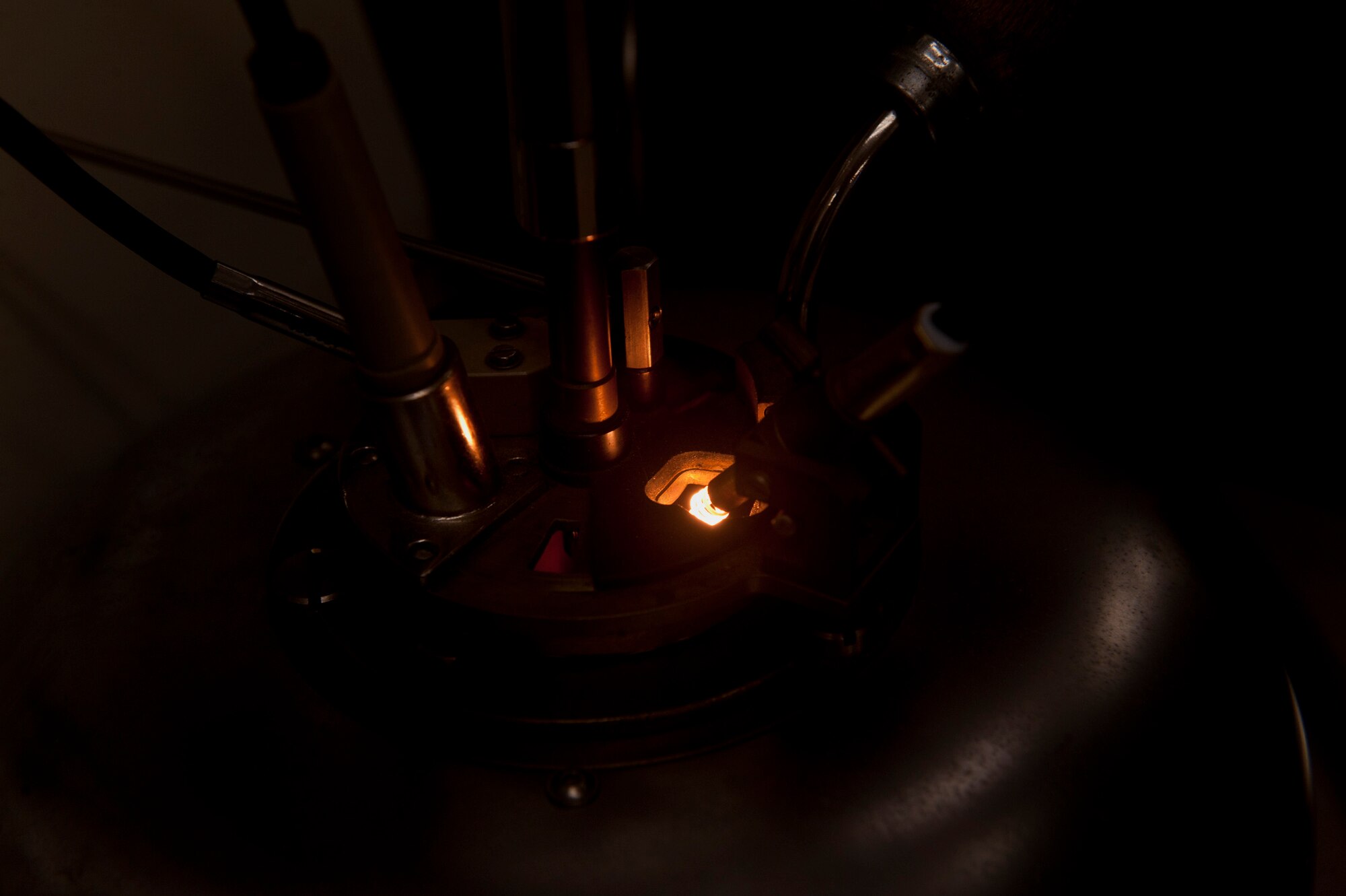 A flash point tester increases heat as it is lowered closer to some JP-8 Jet fuel at Moody Air Force Base, Ga., April 27. Each time the heat source was lowered, the device increased the temperature to test the fuel to determine what temperature will cause the fuel to ignite. (U.S. Air Force photo/Airman 1st Class Douglas Ellis)(RELEASED)
