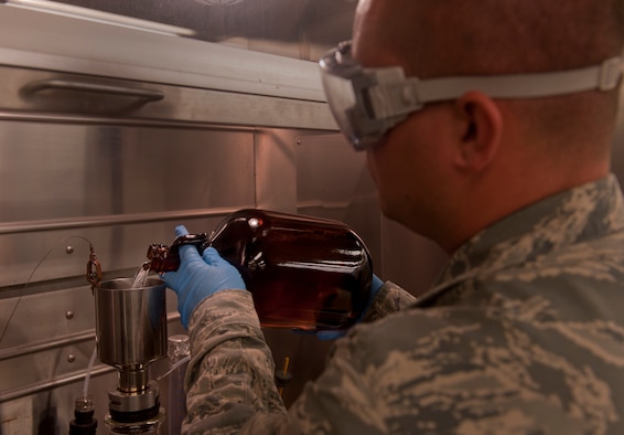 Senior Airman Bryan Jackson, 23rd Logistics Readiness Squadron fuels technician, pours JP-8 jet fuel into a filtration apparatus at Moody Air Force Base, Ga., April 27. The filter ensured there was no solid content in the fuel. (U.S. Air Force photo/Airman 1st Class Douglas Ellis)(RELEASED)

