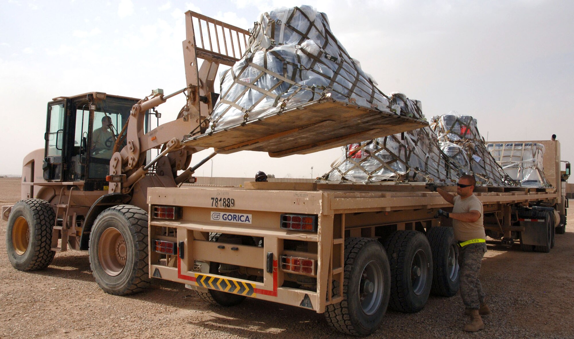 Airmen assigned to the 532nd Expeditionary Operations Support Squadron Air Mobility Flight load a cargo pallet on to a semi-truck April 20, 2011, at Al Asad Air Base, Iraq. The flight recently took on a commercial cargo mission and made history by unloading its first Boeing 747 in April. (U.S. Air Force photo/Staff Sgt. R. Michael Longoria)