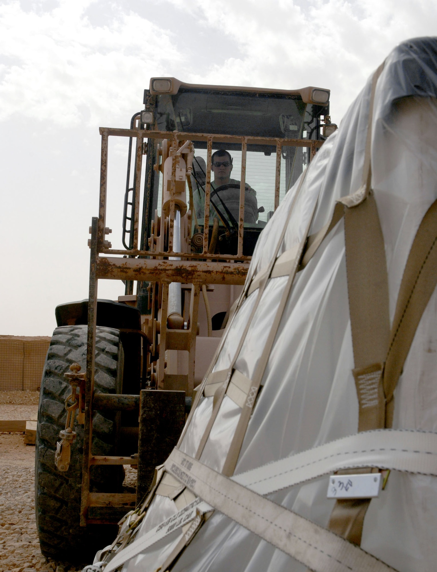 Airman 1st Class James Simpson operates a forklift to move a cargo pallet April 20, 2011, at Al Asad Air Base, Iraq. The flight recently took on a commercial cargo mission and made history by unloading its first Boeing 747 in April. Airman Simpson is an aerial porter assigned to the 532nd Expeditionary Operations Support Squadron Air Mobility Flight. (U.S. Air Force Photo/Staff Sgt. R. Michael Longoria)
