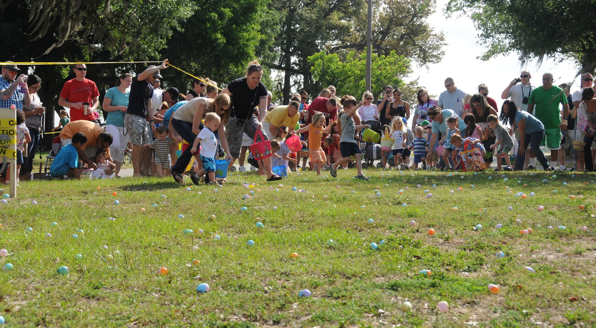 When catering to a toddler’s needs, there’s not much hunting involved in finding Easter eggs — a “smash-and-grab” would be more descriptive. Separate egg hunts were held in different areas of marina park for children in various age groups.  (U.S. Air Force photo by Kemberly Groue)