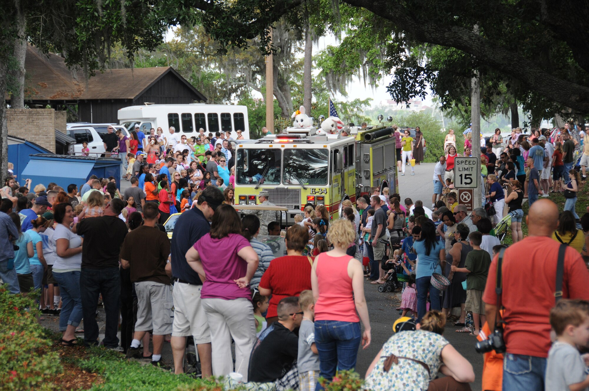 Not one but two Easter bunnies sit atop a bright yellow fire truck waving to onlookers.
A parade welcomed visitors to marina park to kick off Saturday’s Easter egg hunt.  (U.S. Air Force photo by Kemberly Groue)