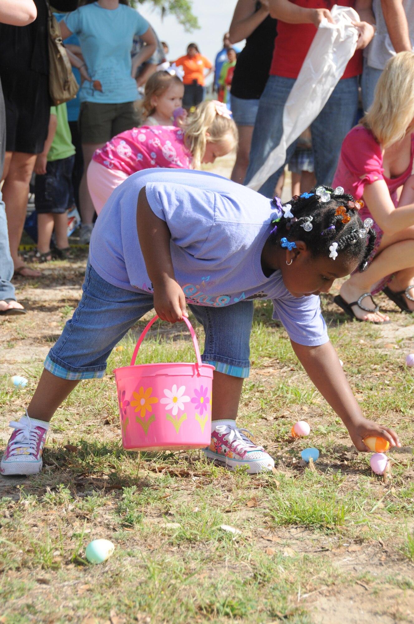 Nadia Coleman, 4, executes her strategy to maximize her Easter egg intake. Nadia is the daughter of Navy Senior Chief William and Cynthia Coleman, 333rd Training Squadron.  (U.S. Air Force photo by Kemberly Groue)
