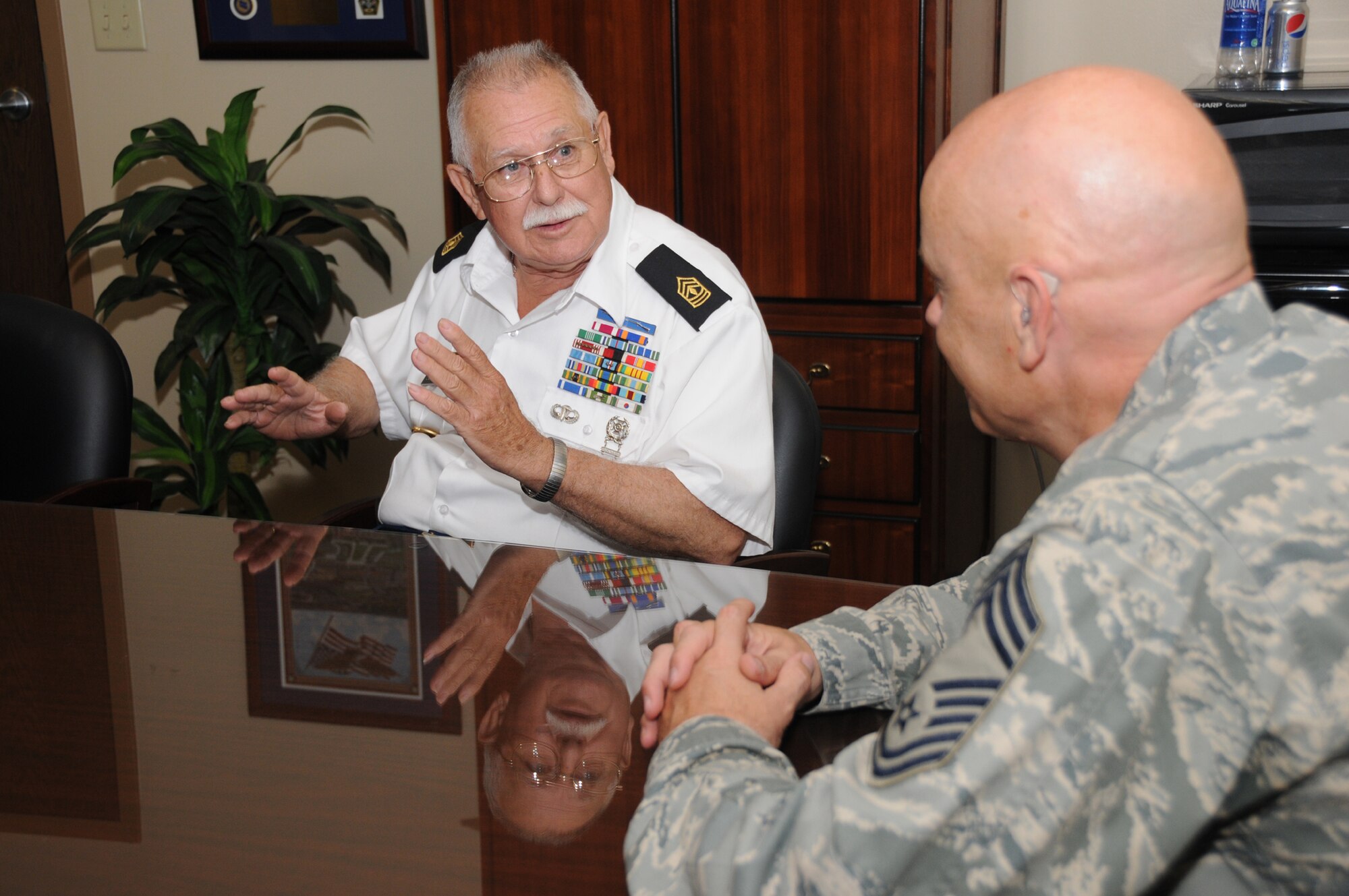 Ray Blanchard Sr., vice commander of Veterans of Foreign Wars Post 2706 of Wiggins, Miss., chats with Chief Master Sgt. Billy Abbott, 81st Training Group superintendent, April 21. Mr. Blanchard, a retired Army first sergeant, and Nancilee Bodine from Bodine Pottery were at Keesler to present certificates and a tile plaque of the Medal of Honor Memorial in Wiggins to Chief Abbott and Col. Lynn Connett, 81st TRG commander, for their participation in the dedication of the memorial on Veterans Day.  (U.S. Air Force photo by Kemberly Groue)