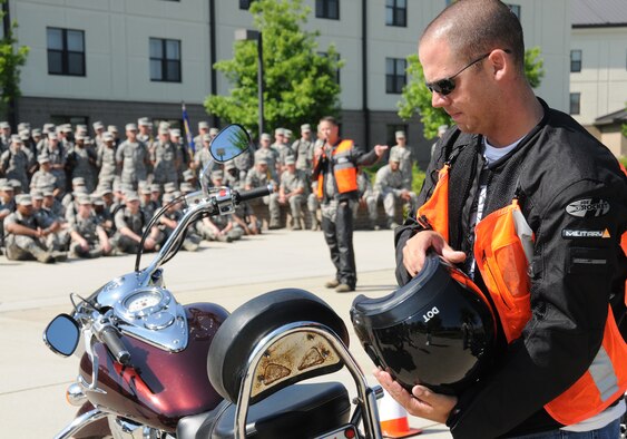 Lt. Col. BrianWorth, center, 336th Training Squadron commander, talks to nonprior service students about motorcycle safety while Staff Sgt. Edward Lotz, 336th TRS military training leader, shows the appropriate apparel for riders during the Red Wolves’ motorcycle safety awareness ride April 22 in front of Holbrook Manor. The purpose of the event was two-fold — to promote safety ethics and techniques among students and to stress awareness of motorcyclists who share the road with other vehicles. Eleven of the squadron’s other motorcyclists joined Colonel Worth and Sergeant Lotz in the ride. The event is a prelude to the 81st Training Wing Motorcycle Safety Week, May 16-20.  (U.S. Air Force photo by Kemberly Groue)