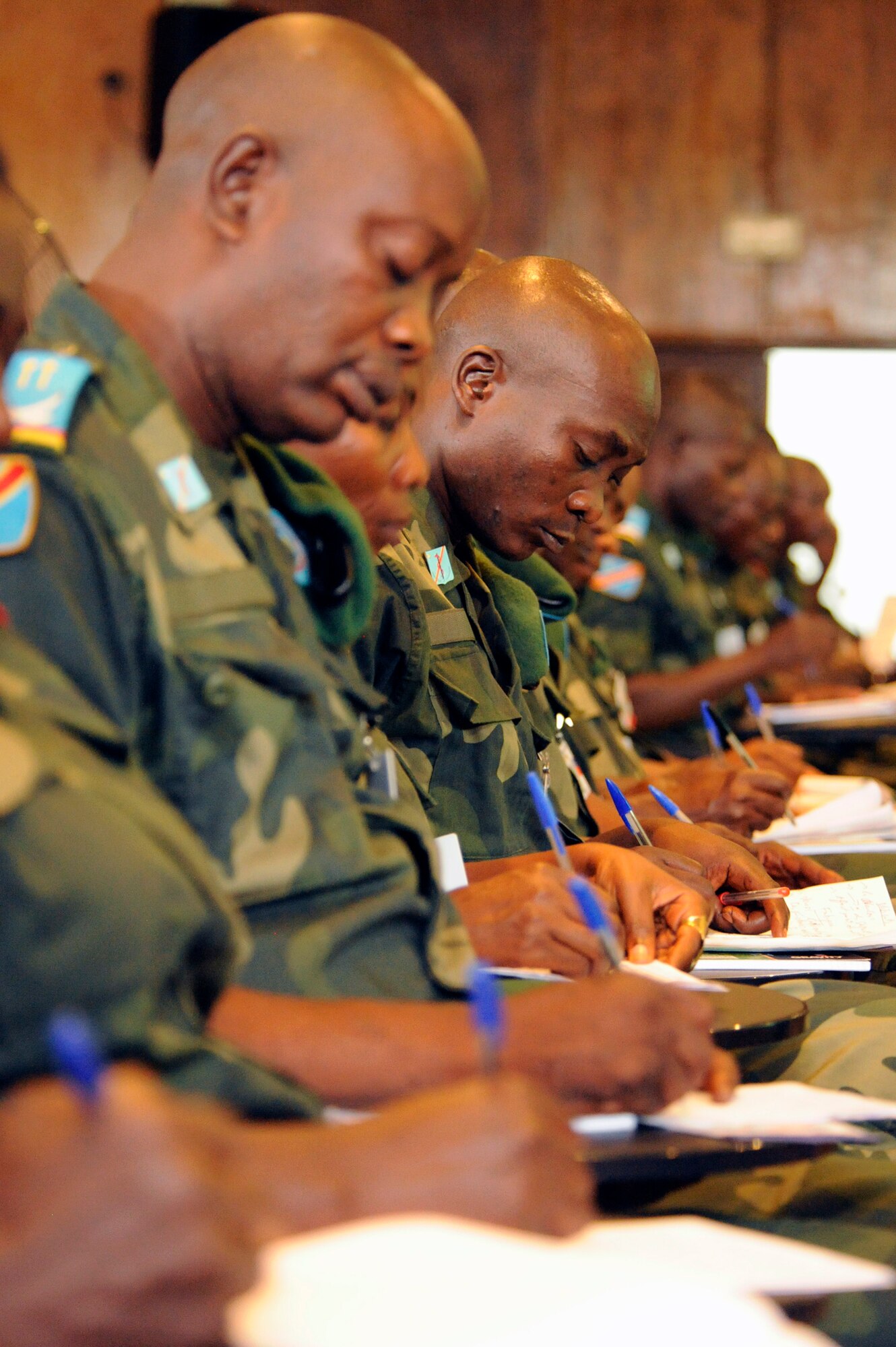 Military members representing the Democratic Republic of the Congo take notes while attending an academic course during MEDLITE 11, April 26, 2011, at Kinshasa, Democratic Republic of the Congo. MEDLITE 11 is a joint medical exercise focused on aeromedical evacuation, to improve the readiness of U.S. Air Force and DRC personnel. (U.S. Air Force photo/Tech. Sgt. Todd Wivell) 