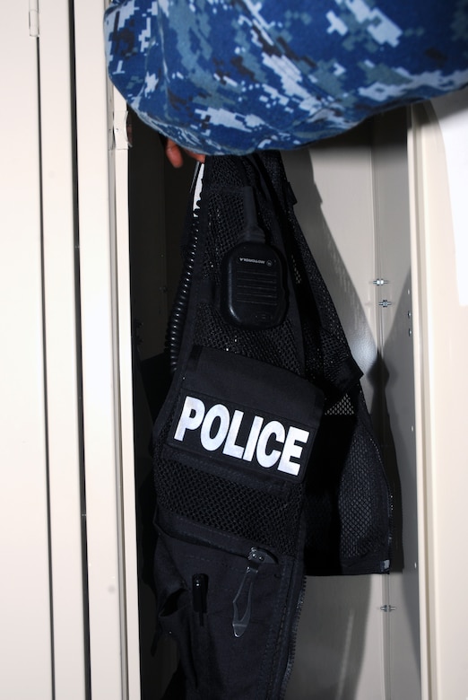 JOINT BASE CHARLESTON, S.C. (April 20, 2011) Master-at-Arms 2nd Class Sherman Whidbee, a patrolman for the 628th Security Forces Squadron, hangs his utility vest in a locker at the end of his shift at Joint Base Charleston-Weapons Station, April 20.  (U.S. Navy photo/Machinist’s Mate 3rd Class Brannon Deugan)