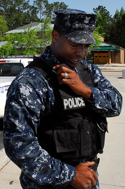 JOINT BASE CHARLESTON, S.C. (April 20, 2011) Master-at-Arms 2nd Class Sherman Whidbee, 628th Security Forces Squadron, reports in to dispatch prior to conducting a foot patrol walk-through of the Naval Exchange at Joint Base Charleston-Weapons Station, April 20.  Routine foot patrols are conducted as a deterrent against criminal activity and to guarantee the safety of patrons utilizing JB Charleston-WS facilities. (U.S. Navy photo/Machinist’s Mate 3rd Class Brannon Deugan)