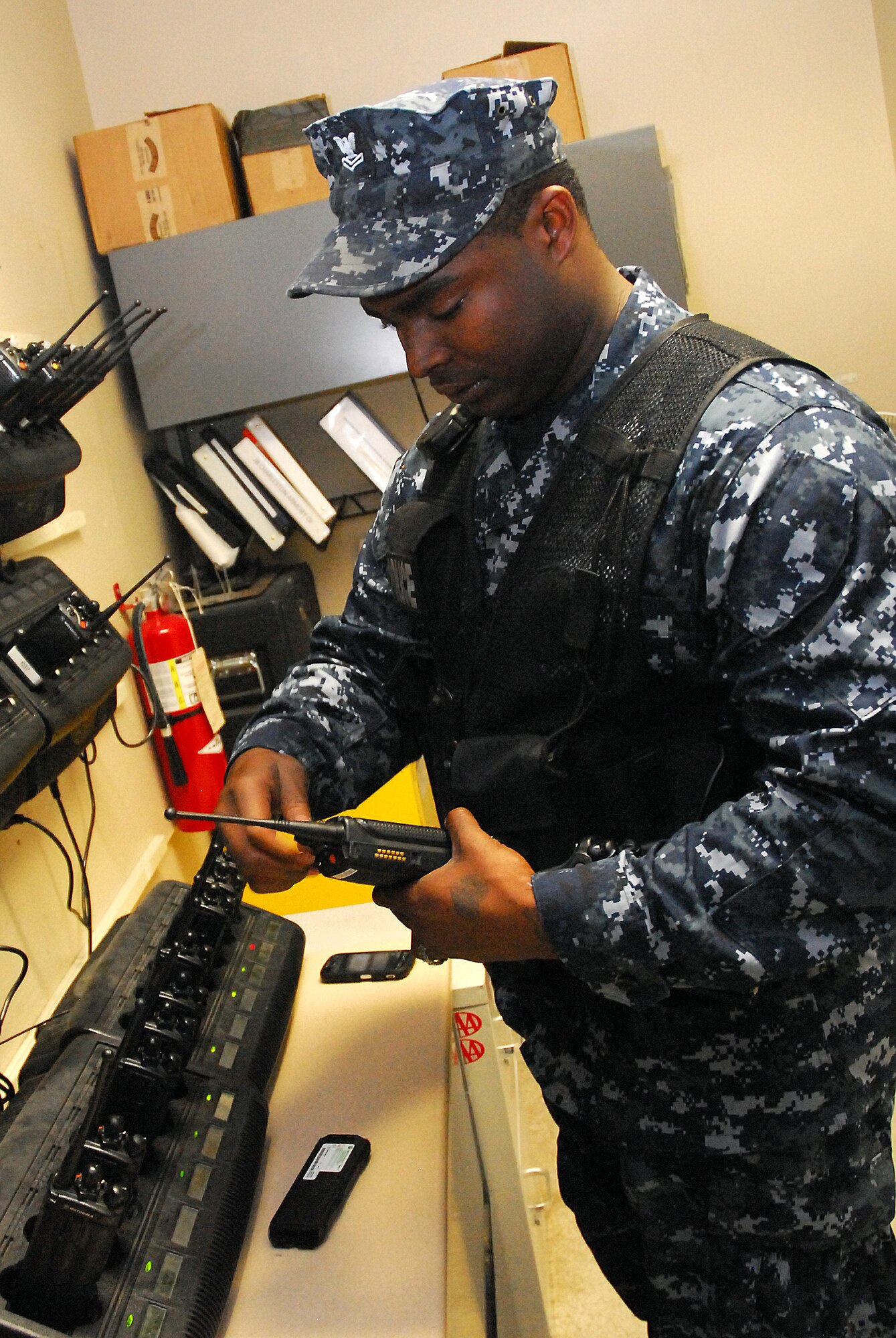 JOINT BASE CHARLESTON, S.C. (April 20, 2011) Prior to beginning his patrol, Master-at-Arms 2nd Class Sherman Whidbee, a patrolman for the 628th Security Forces Squadron, replaces batteries on a two-way radio at Joint Base Charleston-Weapons Station, April 20.  Maintaining communications is essential for the daily operation of security forces. (U.S. Navy photo/Machinist’s Mate 3rd Class Brannon Deugan)