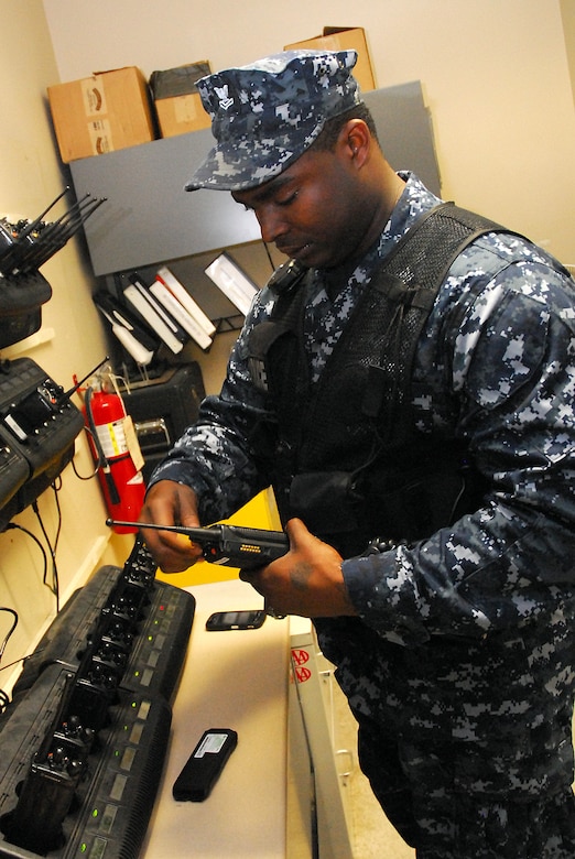 JOINT BASE CHARLESTON, S.C. (April 20, 2011) Prior to beginning his patrol, Master-at-Arms 2nd Class Sherman Whidbee, a patrolman for the 628th Security Forces Squadron, replaces batteries on a two-way radio at Joint Base Charleston-Weapons Station, April 20.  Maintaining communications is essential for the daily operation of security forces. (U.S. Navy photo/Machinist’s Mate 3rd Class Brannon Deugan)