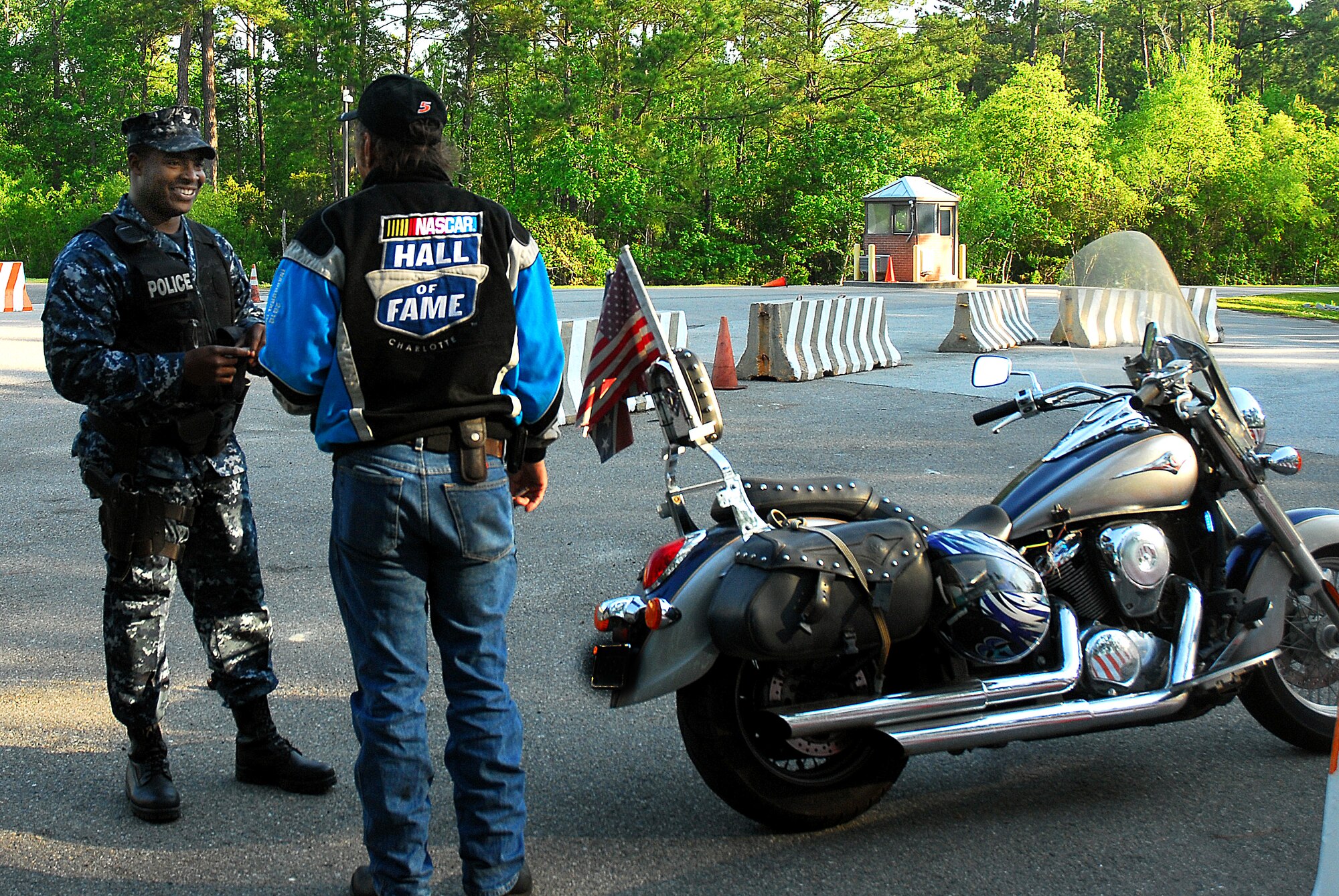 JOINT BASE CHARLESTON, S.C. (April 20, 2011) Patrolman Master-at-Arms 2nd Class Sherman Whidbee, 628th Security Forces Squadron, informs a motorcycle rider about the required personal protective equipment for riding a motorcycle on Joint Base Charleston-Weapons Station, April 20.  (U.S. Navy photo/Machinist’s Mate 3rd Class Brannon Deugan)