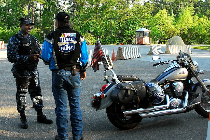 JOINT BASE CHARLESTON, S.C. (April 20, 2011) Patrolman Master-at-Arms 2nd Class Sherman Whidbee, 628th Security Forces Squadron, informs a motorcycle rider about the required personal protective equipment for riding a motorcycle on Joint Base Charleston-Weapons Station, April 20.  (U.S. Navy photo/Machinist’s Mate 3rd Class Brannon Deugan)