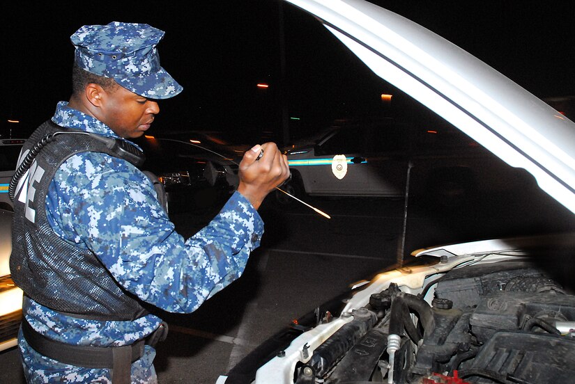 JOINT BASE CHARLESTON, S.C. (April 21, 2011) Master-at-Arms 2nd Class Sherman Whidbee, a patrolman for the 628th Security Forces Squadron, performs maintenance on his patrol vehicle at Joint Base Charleston-Weapons Station, April 20.  Each patrolman is required to conduct a thorough check of their vehicle before starting their patrols. (U.S. Navy photo/Machinist’s Mate 3rd Class Brannon Deugan)