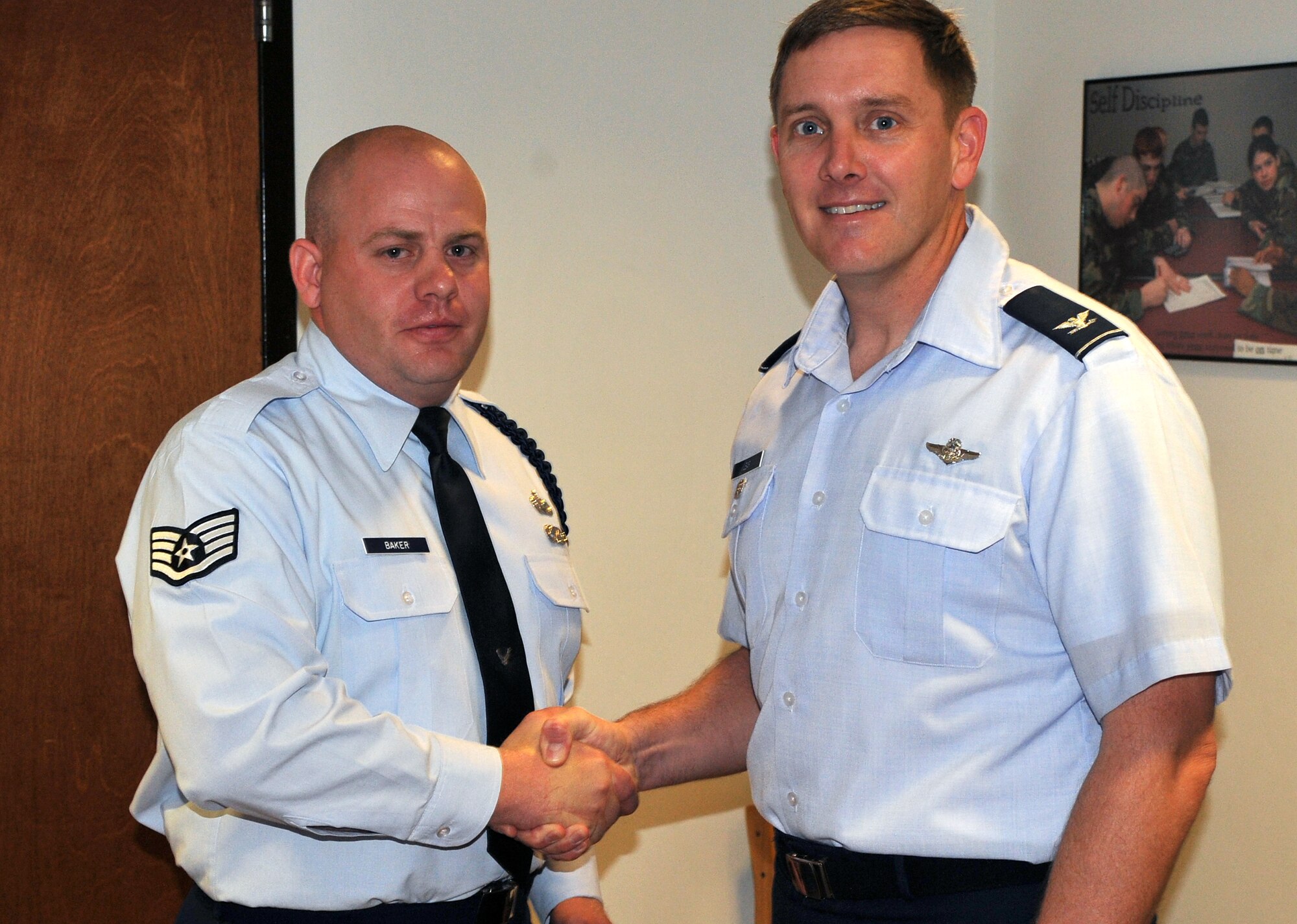 Col. Kirk Lear (right), 314th Airlift Wing vice commander, presents a commander’s coin April 25, 2011, at Little Rock Air Force Base, Ark., to Staff. Sgt. Cory Baker, a 714th Training Squadron military training leader, for his selection as the Combat Airlifter of the Week. Sergeant Baker has mentored more than 220 non-prior enlisted aviators and enforces strict Air Force standards and discipline. (U.S. Air Force photo by Staff Sgt. Chris Willis)