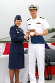 JOINT BASE CHARLESTON, S.C. (April 22, 2011) Lt. Gregory Dietzen receives the Vice Adm. Behrens award plaque, awarded to the graduating officer with the highest grade-point-average, from keynote speaker Col. Martha Meeker during the Navy Nuclear Power Training Command graduation ceremony for class 1101 at Joint Base Charleston-Weapons Station, April 22. Lieutenant Dietzen earned an overall GPA of 3.91, the highest in the school's history. Colonel Meeker is the Joint Base Charleston commander. (U.S. Navy photo/Machinist’s Mate 3rd Class Brannon Deugan) 
