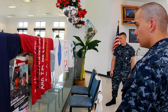 JOINT BASE CHARLESTON, S.C. (April 25, 2011) Machinist’s Mate Fireman Jeffry Spiegel (left) and Machinist’s Mate Fireman Edward Knox, of Detaching Transient Personnel, look over the sexual assault awareness clothesline at the Weapons Station galley at Joint Base Charleston-Weapons Station, April 25.  The clothesline displays t-shirts designed by survivors of a sexual assault, bringing a creative voice to stand out against sexual violence and to raise awareness throughout the JB CHS-WS community. (U.S. Navy photo/Machinist’s Mate 3rd Class Brannon Deugan)