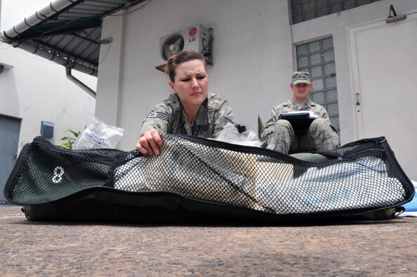 Staff Sgt. Amber Weaver, an Aeromedical Evacuation Technician with the Wyoming Air National Guard's 187th Aeromedical Evacuation Squadron (foreground) conducts an inventory on inflight medical kits while Tech. Sgt. Matt Larson, a Medical Material Craftsman with the Minnesota ANG's 109th AES reads off the inventory checklist as part of MEDLITE 11 preparation, April 26, 2011 at the U.S. Embassay here. MEDLITE 11 is a joint medical exercise focused on aeromedical evacuation, to improve the readiness of U.S. Air Force and DRC personnel. (U.S. Air Force photo by Tech. Sgt. John Orrell) 
