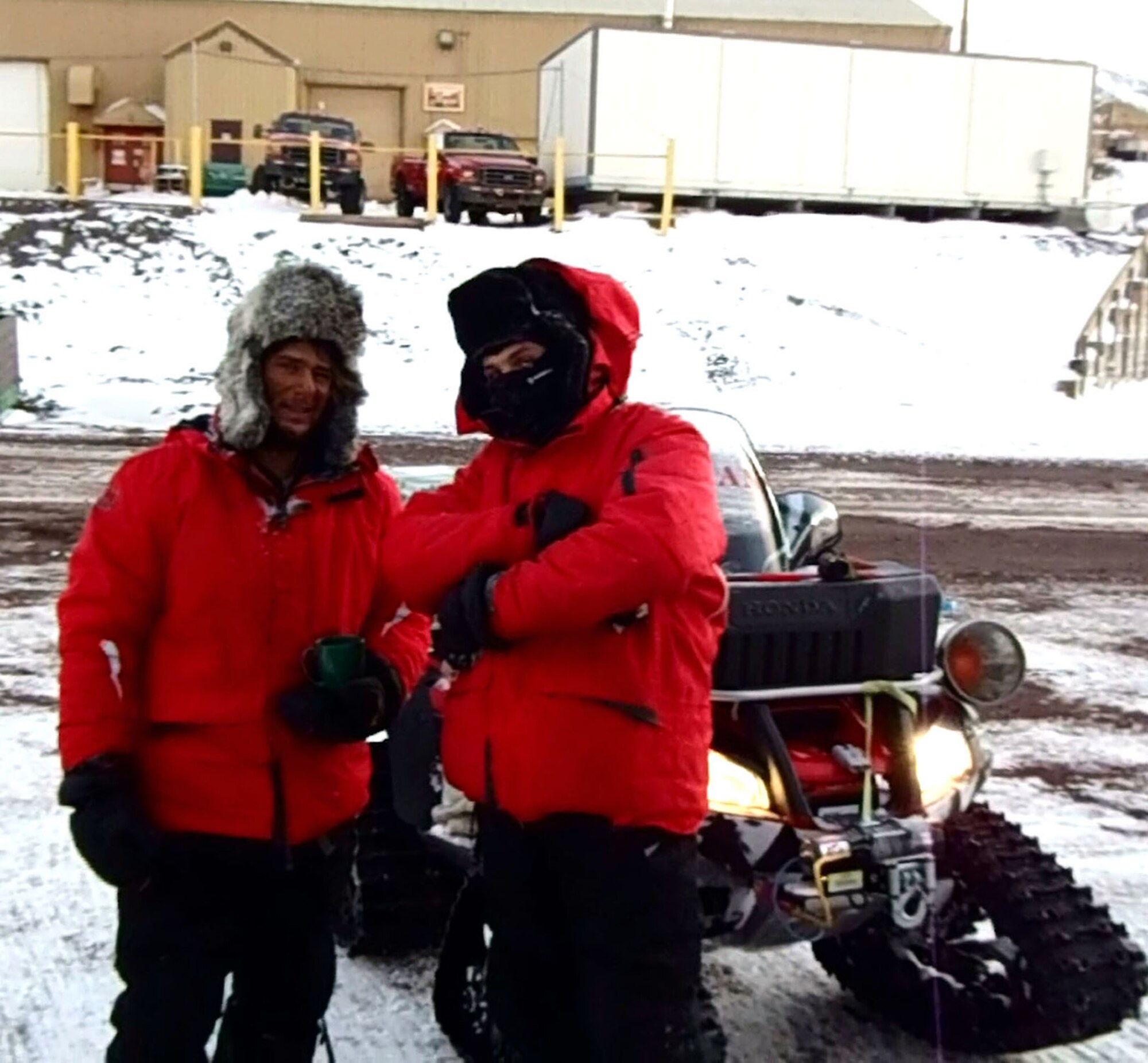 TRAVIS AIR FORCE BASE, Calif. -- Two of the winter residents sharing McMurdo Station with Chief Master Sgt. Michael Beck, show off the latest in winter transportation and freezing weather fashion. The Chief is on an eight month assignment for his civilian company to McMurdo Station, Antarctica, where he is putting his Air Force training to good use as well. (Courtesy photo)