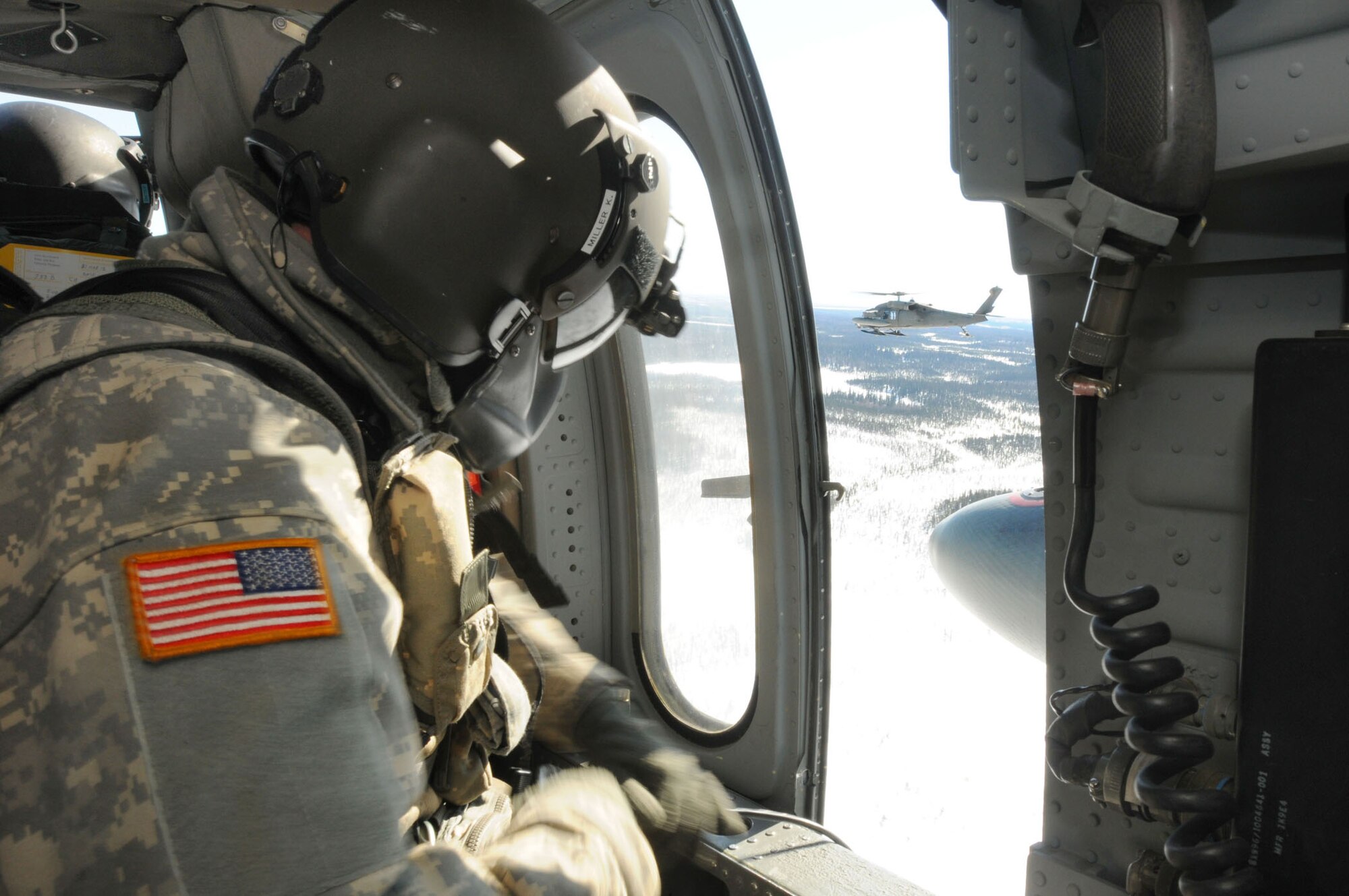 An Alaska Army National Guard crew chief maintains watch during a resupply mission April 16, 2011, in support of Operation Arctic Care 2011. (U.S. Air Force photo/Lt. Col. Brent Campbell)