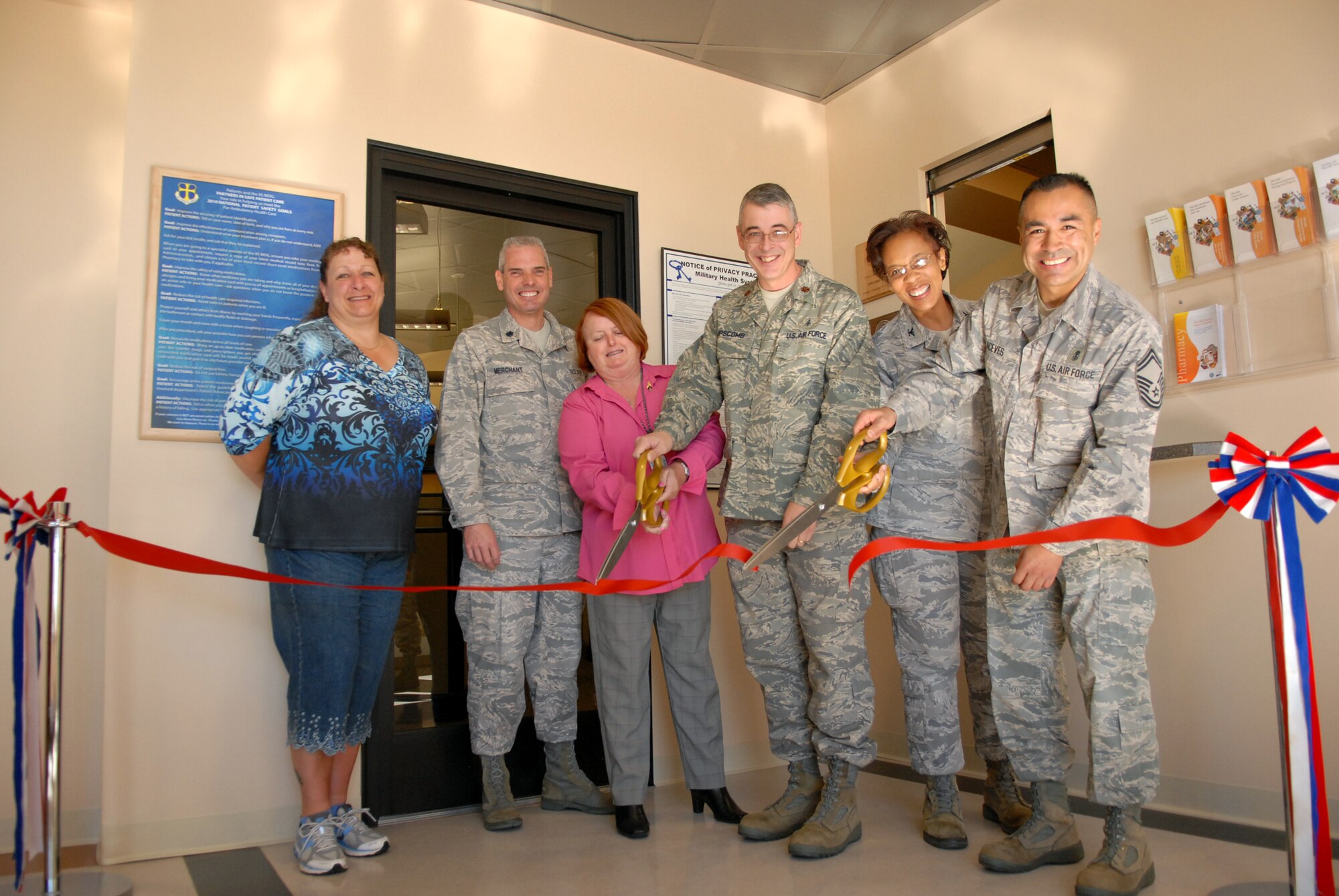 From left: Wanita Williams, 95th Medical Group facility manager, Lt. Col. Ronald Merchant 95th Medical Support Squadron commander, Lyn King, 95th MDG TRICARE Operations and Patient Administration Flight beneficiary counselor, Maj. Thomas Liscomb, 95th MDSS TOPA Flight commander, Col. Janet Taylor, 95th MDG commander and Senior Master Sgt. Mario Aceves, 95th Medical Operations Squadron superintendant are happy to officially open the new TOPA area, April 22, located on the first floor of the Edwards medical clinic. The area will allow for the consolidation of TRICARE functions that were previously spread out between two floors. (Air Force photo by Kate Blais)