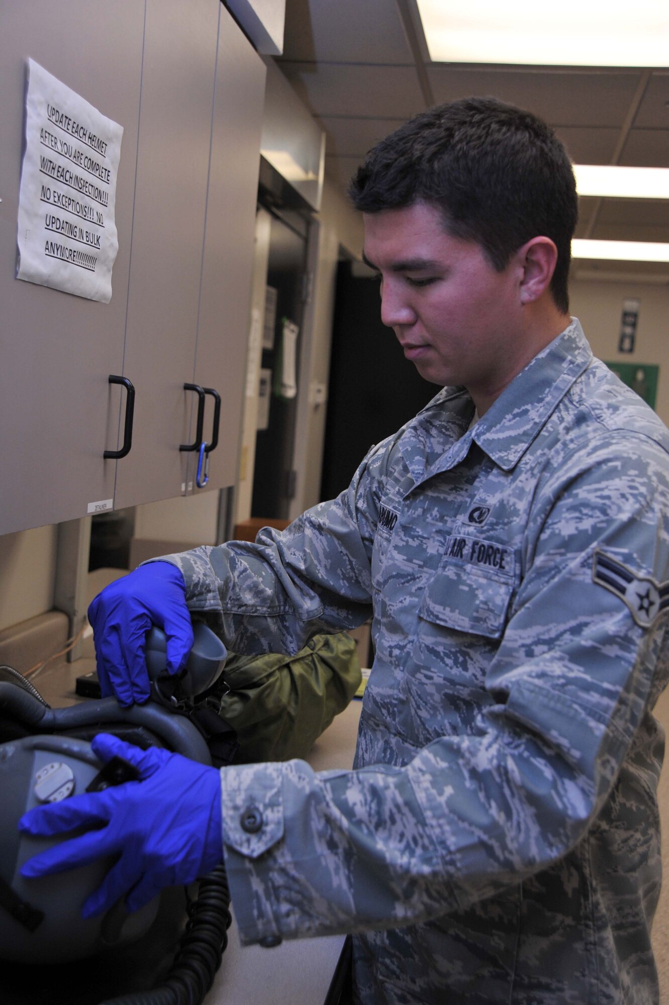 Airman 1st Class Andrew Yabumoto, 22nd Operations Support Squadron Aircrew flight equipment journeyman, inspects pilots’ helmets April 27, 2011, McConnell Air Force Base, Kan.  The Las Cruces, N.M., native’s job includes managing, performing, scheduling inspections, maintaining and adjusting McConnell’s assigned aircrew flight equipment, aircrew chemical defense equipment, associated supplies and inventory assets.  (U.S. Air Force photo/Senior Airman Abigail Klein)