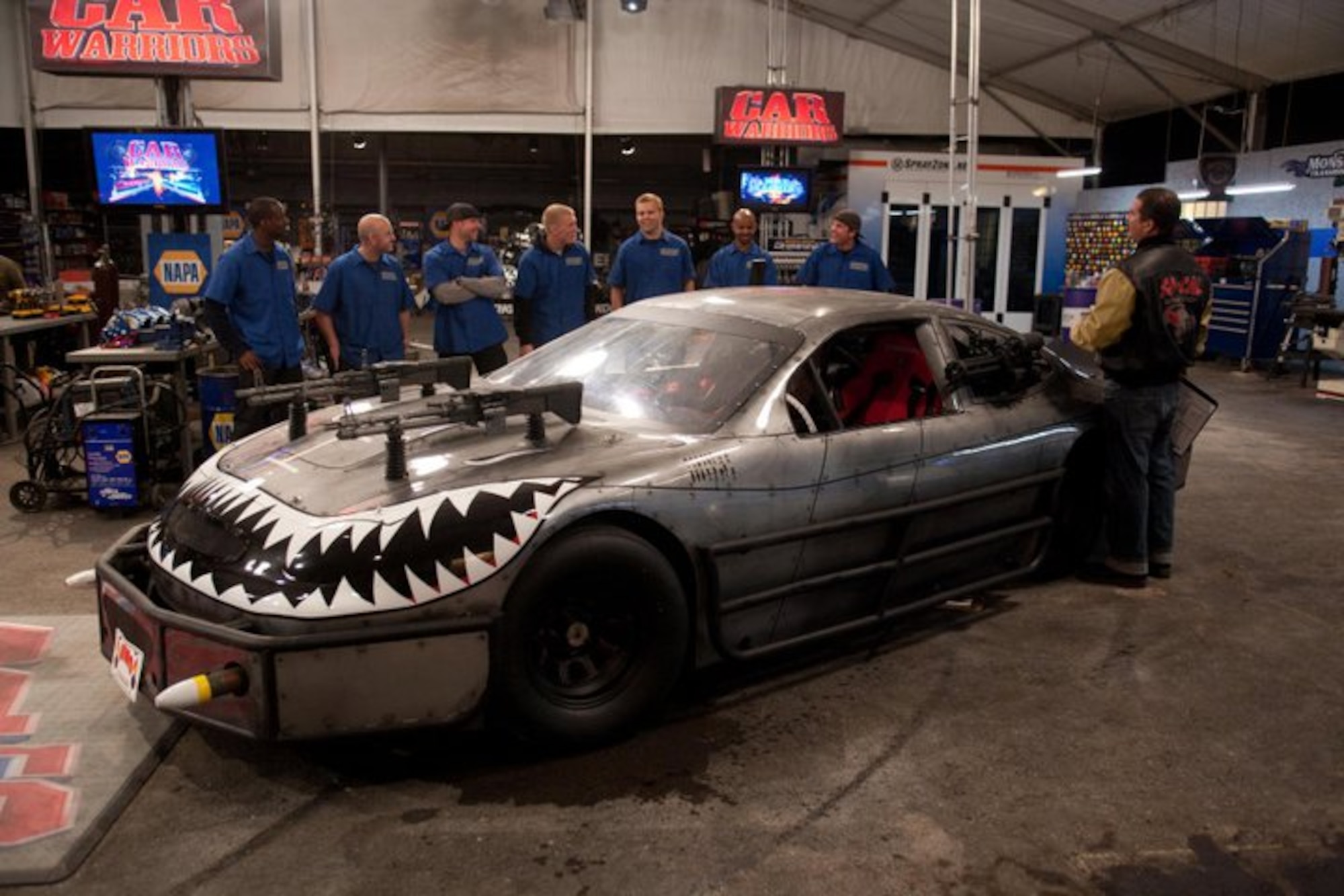 A team of Airmen from Edwards stand behind their four-wheeled "A-10" on the set of "Car Warriors," a car-building competition series on the Speed Channel. The Air Force team had 36 hours to plan and build a "NASCAR Death Race Machine" from a bare race car. The group of Airmen took home bragging rights after beating the All-Star team of show regulars with a better finished product. (Courtesy photo)