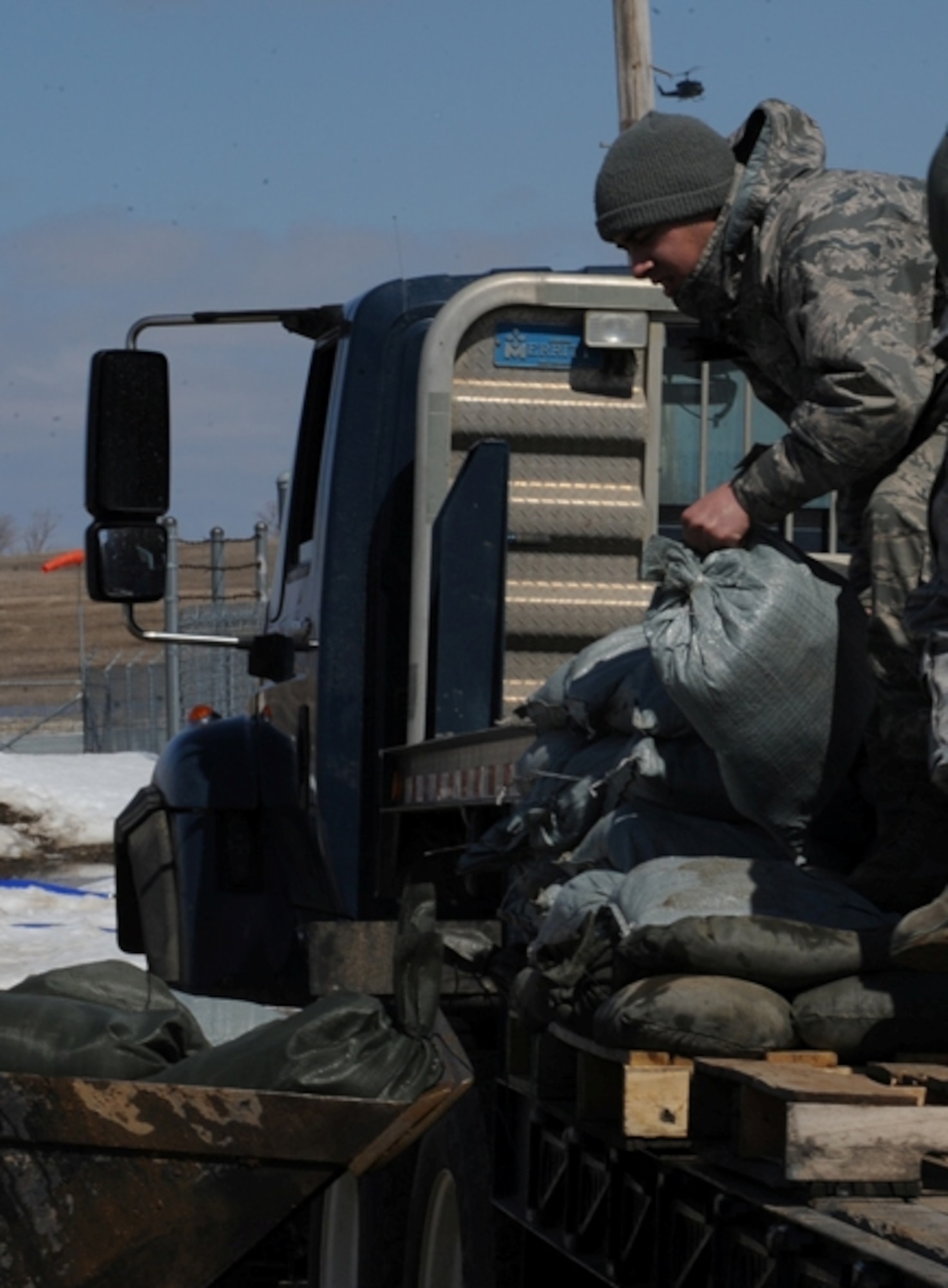 WARD COUNTY, N.D. -- A 91st Missile Wing Airman loads sandbags into
a Bobcat vehicle here April 13. The base is prepared to handle these types of events through robust readiness plans and are taking the appropriate steps to mitigate the effects of increased water levels. (U.S. Air Force photo/Airman 1st Class Aaron-Forrest Wainwright)
