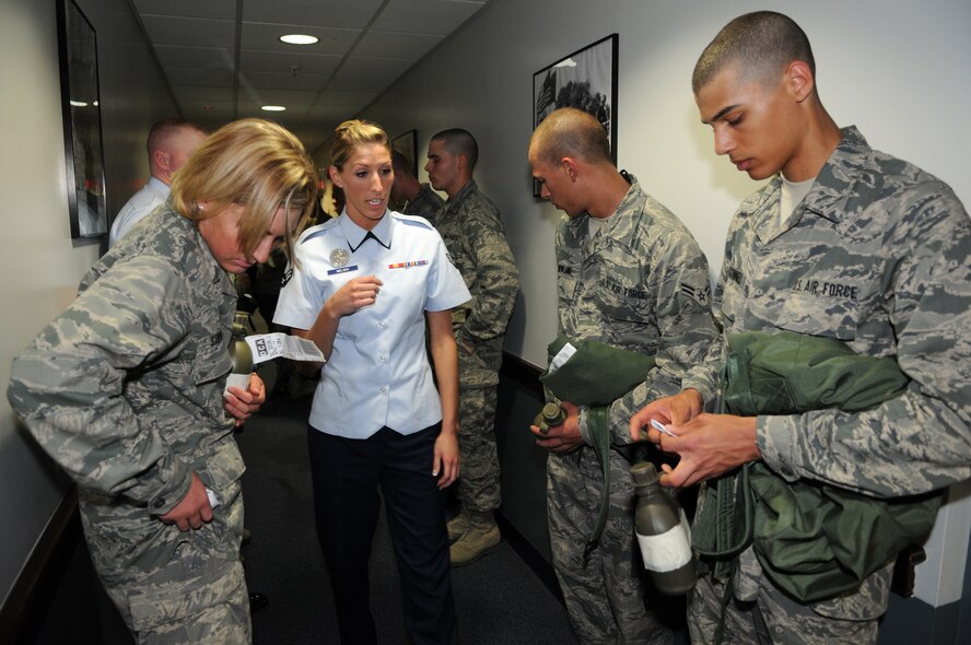 Airman 1st Class Amber Nielsen, training instructor for the U.S. Air Force Honor Guard, educates Honor Guard trainees on dorm procedures April 25, at Joint Base Anacostia-Bolling, Washington, D.C. The new trainees complete eight weeks of technical training before they are qualified to participate in The USAF Honor Guard’s mission at Arlington National Cemetery. (U.S. Air Force photo by Senior Airman Christopher Ruano)