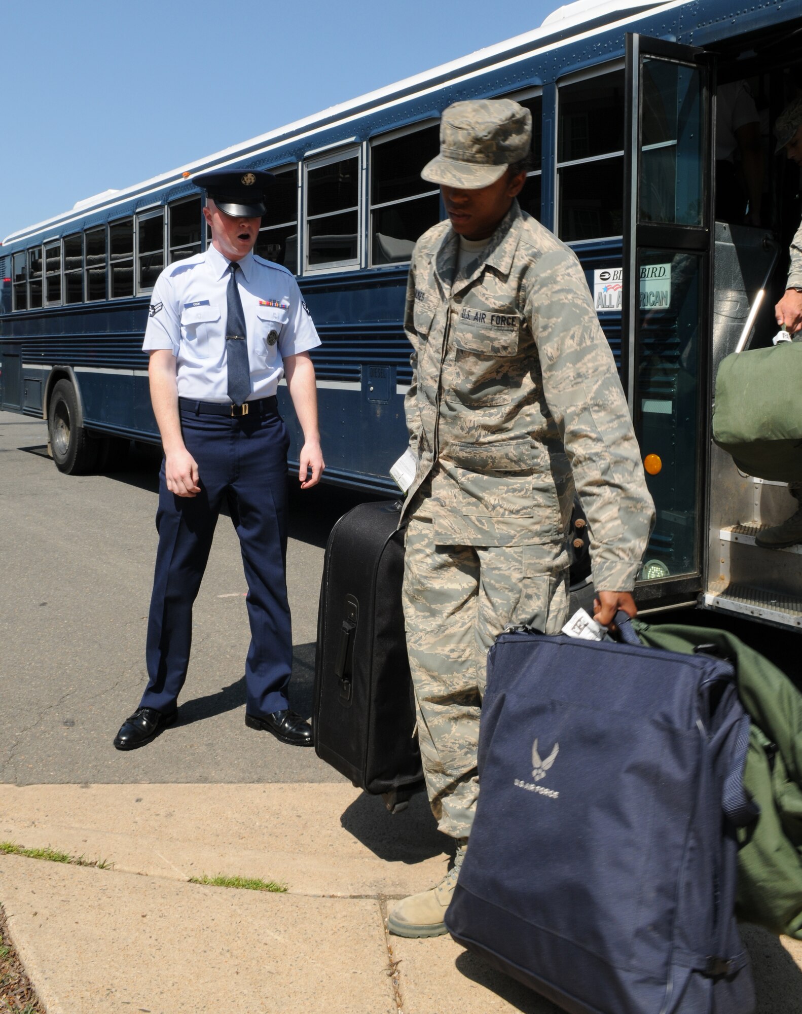 Airman 1st Class Kylee Cook, U.S. Air Force Honor Guard training Instructor, orders trainees off the bus, while USAF Honor Guard trainee, Airman Temeri Julkes rockets off the bus to join her fellow Honor Guard trainees April 25, at Joint Base Anacostia-Bolling, Washington, D.C. Airmen must move with haste and precision in all they do during and after their eight-week technical training course. (U.S. Air Force photo by Senior Airman Christopher Ruano)