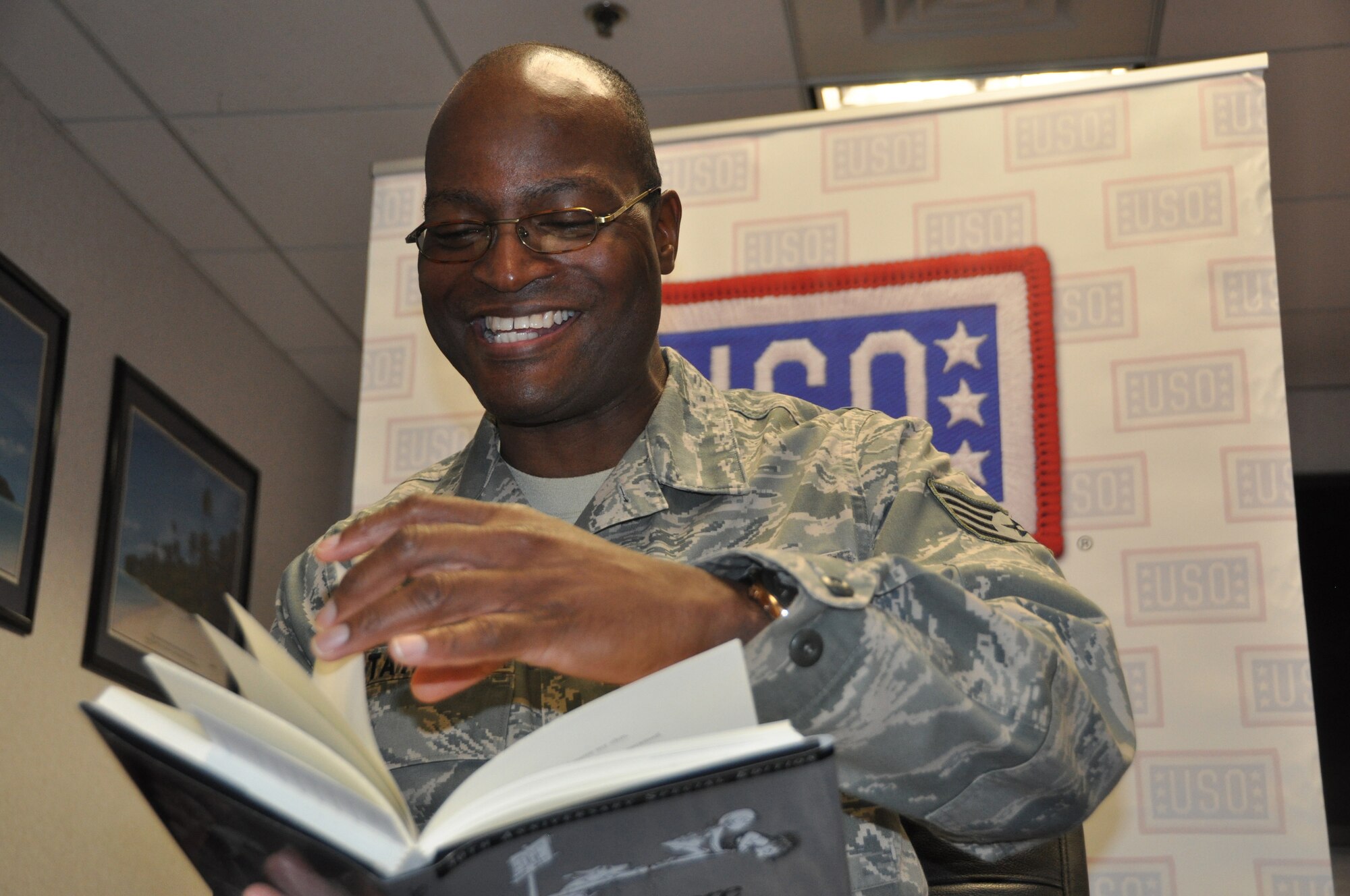 JOINT BASE MCGUIRE-DIX-LAKEHURST, N.J. - Staff Sgt. Darrell Taylor, a deploying reservist, takes part in a USO and United Through Reading Military Program April 22. The reading program allows deploying military members to have a video recording made of them reading a book. The video and book are then sent to their children to enjoy while their parent is away. (U.S. Air Force photo/Master Sgt. Donna T. Jeffries)  