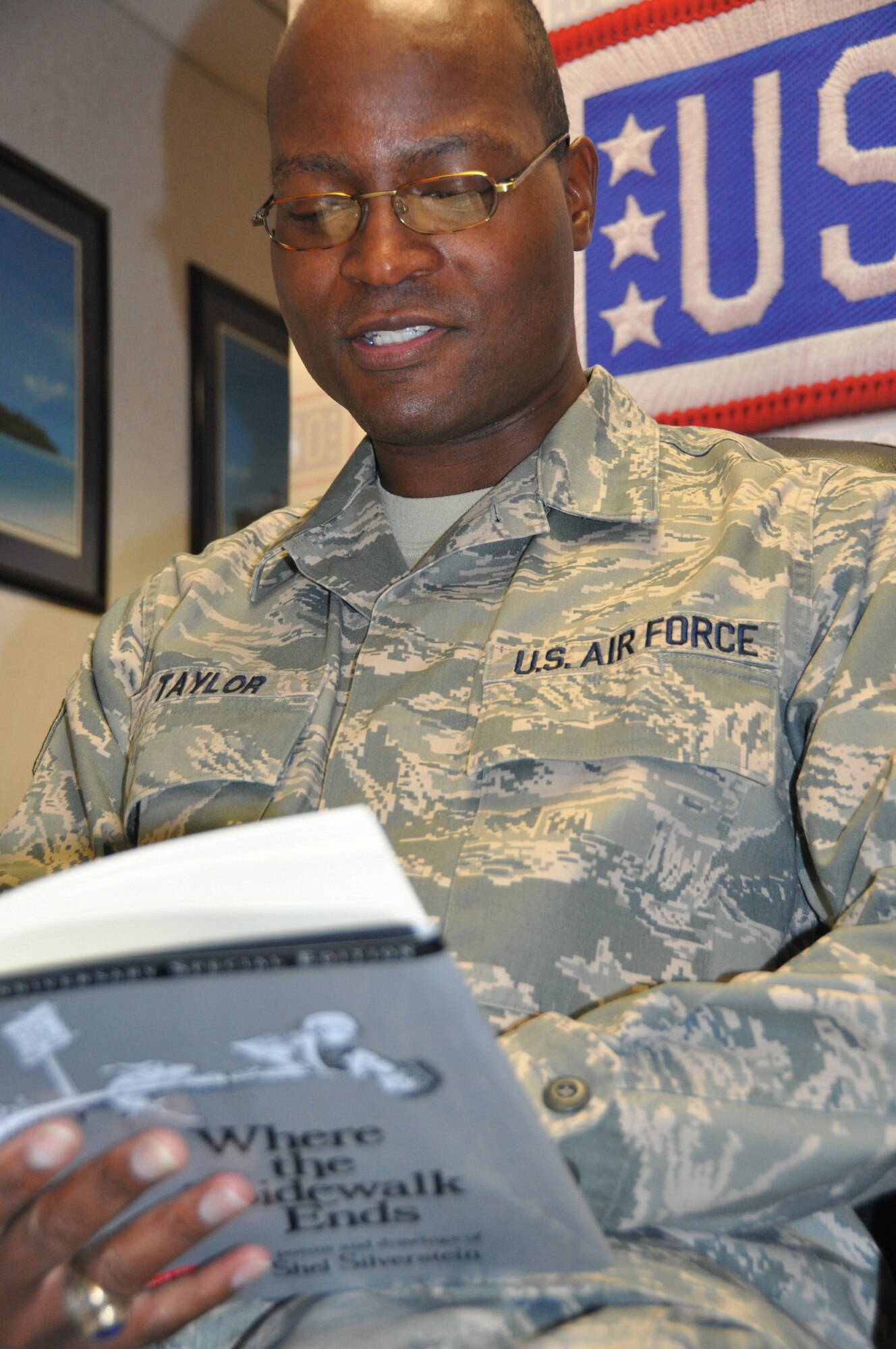 JOINT BASE MCGUIRE-DIX-LAKEHURST, N.J. - Staff Sgt. Darrell Taylor, a deploying reservist, takes part in a USO and United Through Reading Military Program April 22. The reading program allows deploying military members to have a video recording made of them reading a book. The video and book are then sent to their children to enjoy while their parent is away. (U.S. Air Force photo/Master Sgt. Donna T. Jeffries)  