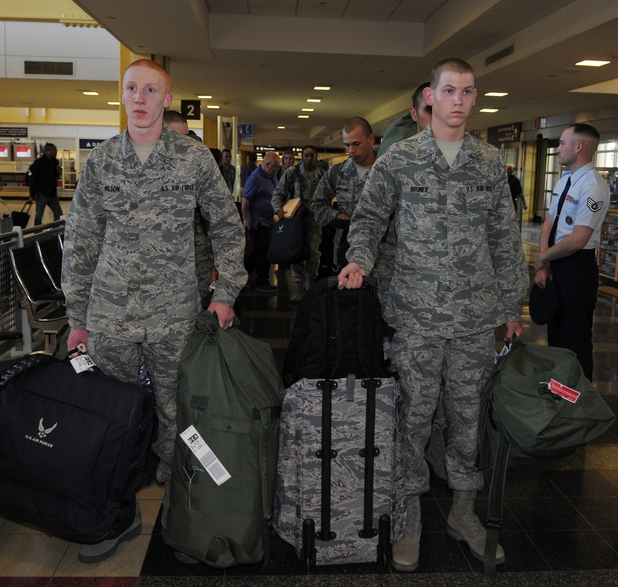 U.S. Air Force Honor Guard trainees, Airman Alexander Wilson and Airman Alec Bruner wait patiently for their wingmen as they retrieve bags April 25, at Washington’s Ronald Reagan National Airport. Upon arriving at the airport, training starts. Orders are issued by Honor Guard training leaders and trainees are expected to comply immediately. (U.S. Air Force photo by Senior Airman Christopher Ruano)