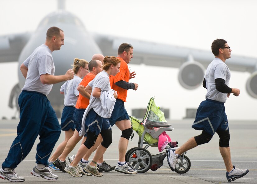 Team Dover members run down the flightline April 20, 2011, during the Chocolate Easter Bunny Warrior Run at Dover Air Force Base, Del. Warrior Runs are held every month and usually have a theme to fit the month in which they are held. (U.S. Air Force photo by Roland Balik) 

