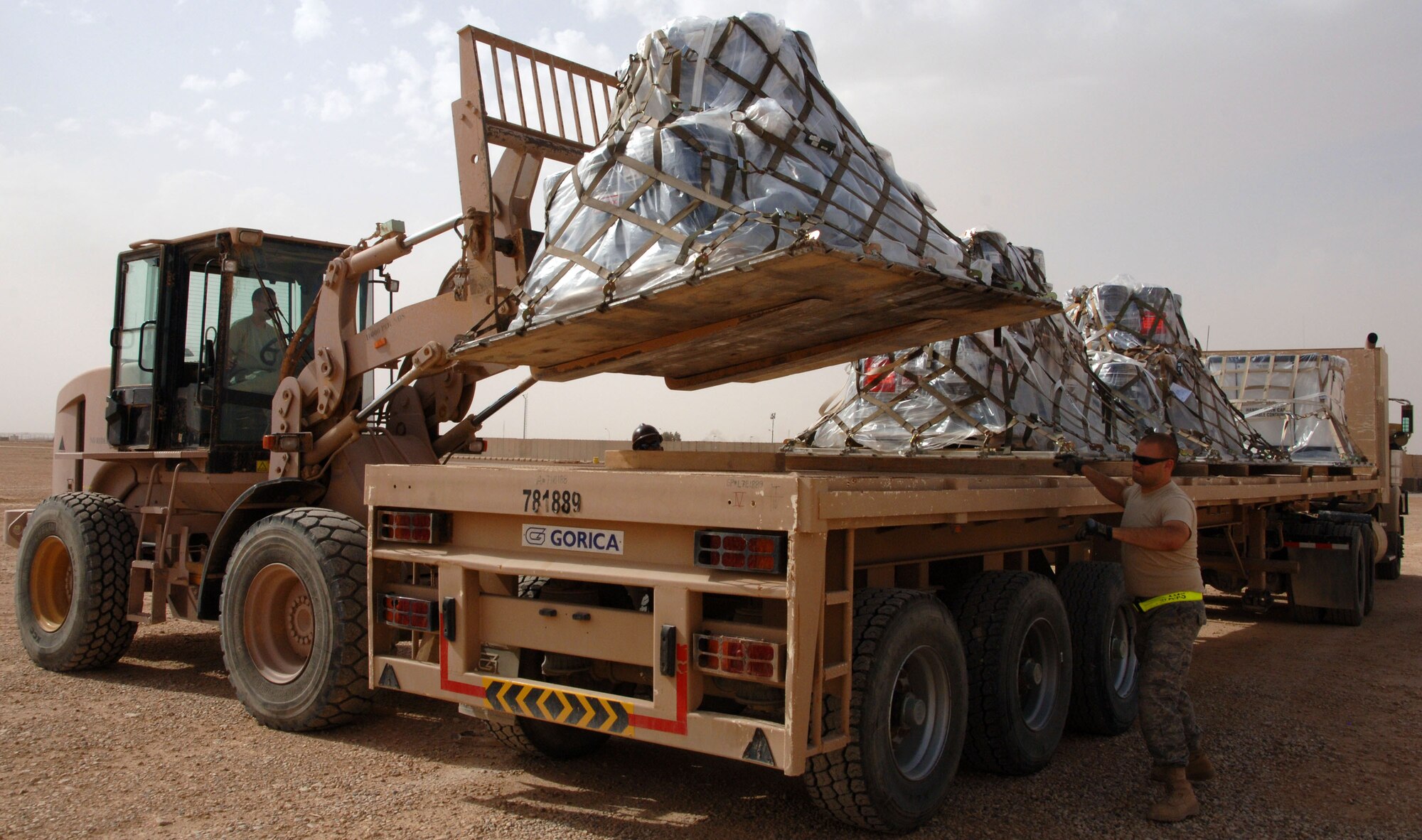 Airmen assigned to the 532nd Expeditionary Operations Support Squadron Air Mobility Flight load a cargo pallet on to a semi-truck April 20, 2011, at Al Asad Air Base, Iraq. The flight recently took on a commercial cargo mission and made history by unloading its first 747 earlier this month. Since then the aerial porters have offloaded three more 747s, which can hold up to 42 pallets each. (U.S. Air Force photo by Staff Sgt. R. Michael Longoria/Released)