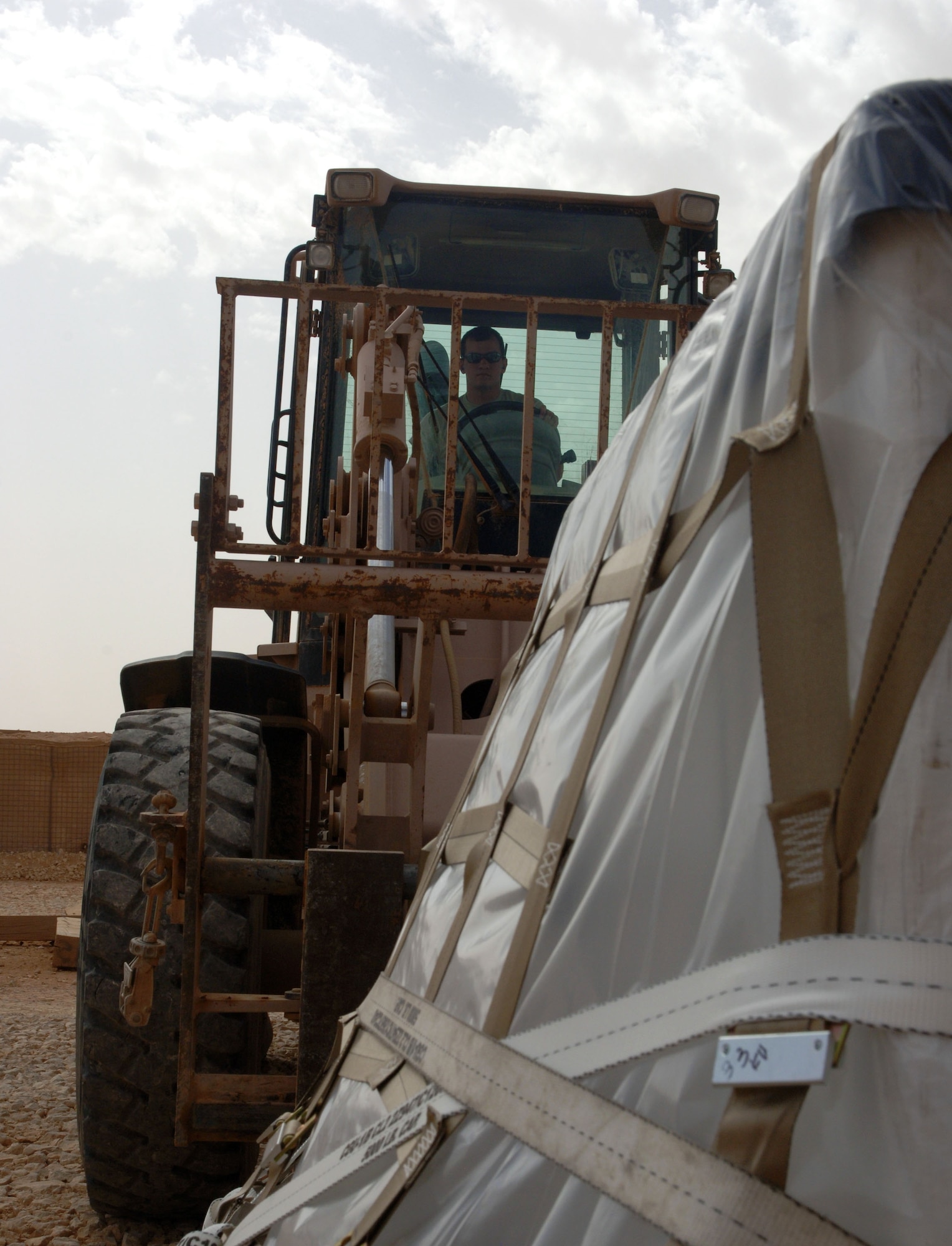 Airman 1st Class James Simpson, 532nd Expeditionary Operations Support Squadron Air Mobility Flight aerial porter, operates a forklift to move a cargo pallet April 20, 2011, at Al Asad Air Base, Iraq. The flight recently took on a commercial cargo mission and made history by unloading its first 747 earlier this month. Airman Simpson is an El Dorado, Ark., native deployed from deployed from Pope Field, N.C. (U.S. Air Force photo by Staff Sgt. R. Michael Longoria/Released)