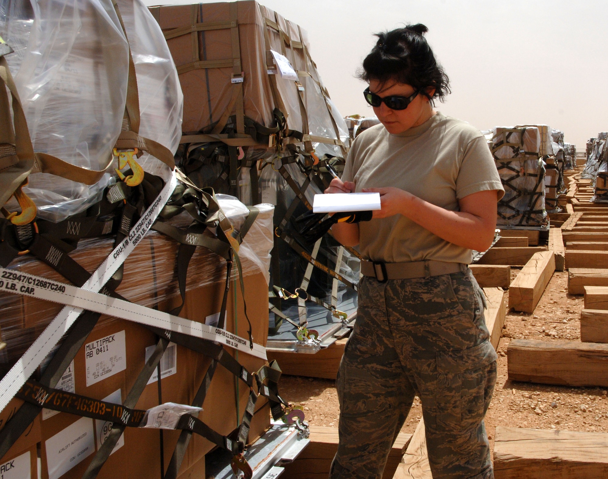 Airman 1st Class Arielle Schultz, 532nd Expeditionary Operations Support Squadron Air Mobility Flight aerial porter, inventories cargo April 20, 2011, at Al Asad Air Base, Iraq. The flight recently took on a commercial cargo mission and made history by unloading its first 747 earlier this month. Airman Schultz is a Taunton, Mass., native deployed from Joint Base Elmendorf-Richardson, Alaska. (U.S. Air Force photo by Staff Sgt. R. Michael Longoria/Released)