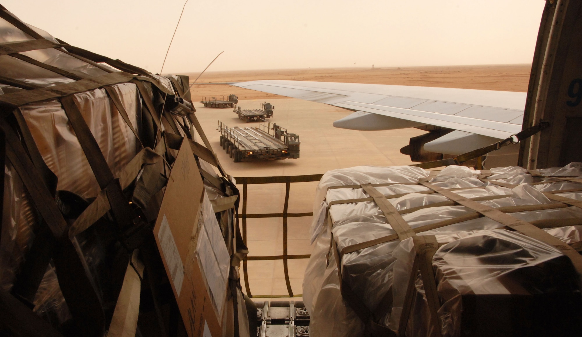 Airmen assigned to the 532nd Expeditionary Operations Support Squadron Air Mobility Flight  line up 60K cargo loaders to offload a commercial 747 April 20, 2011, at Al Asad Air Base, Iraq. The flight recently took on a commercial cargo mission and made history by unloading its first 747 earlier this month. Since then the aerial porters have offloaded three more 747s, which can hold up to 42 pallets each. (U.S. Air Force photo by Staff Sgt. R. Michael Longoria/Released)