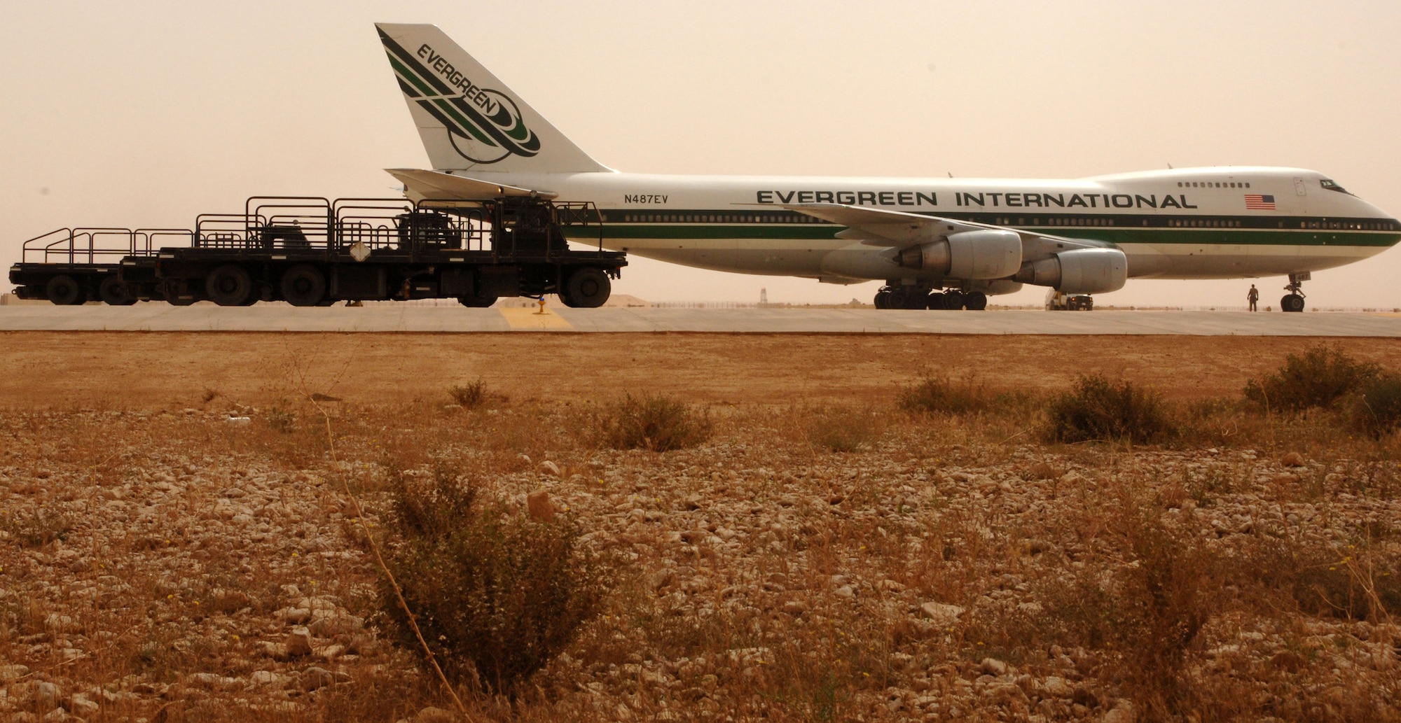 Airmen assigned to the 532nd Expeditionary Operations Support Squadron Air Mobility Flight  line up 60K cargo loaders next to a commercial 747 April 20, 2011, at Al Asad Air Base, Iraq. The flight recently took on a commercial cargo mission and made history by unloading its first 747 earlier this month. Since then the aerial porters have offloaded three more 747s, which can hold up to 42 pallets each. (U.S. Air Force photo by Staff Sgt. R. Michael Longoria/Released)