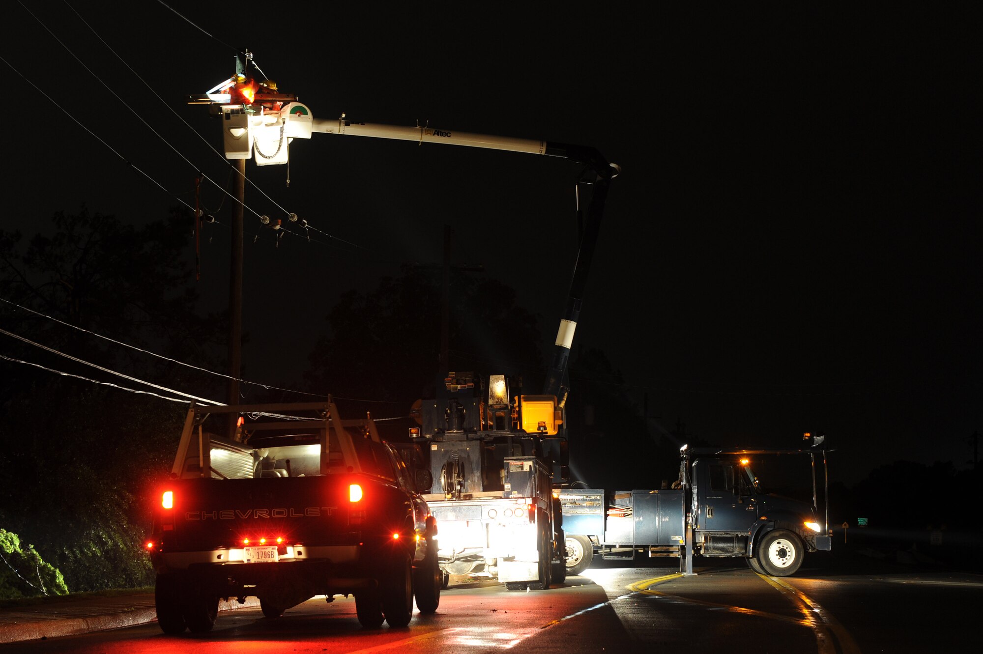 Little Rock Air Force Base Airmen and civilian employees from the 19th Civil Engineering Squadron work in the wee hours of the morning April 27 to restore power to base housing after a tornado struck the base April 25. More than 100 houses in the base's housing area were damaged along with at least three C-130 Hercules aircraft and numerous buildings where Airmen work. (U.S. Air Force photo by Tech Sgt. Chad Chisholm)